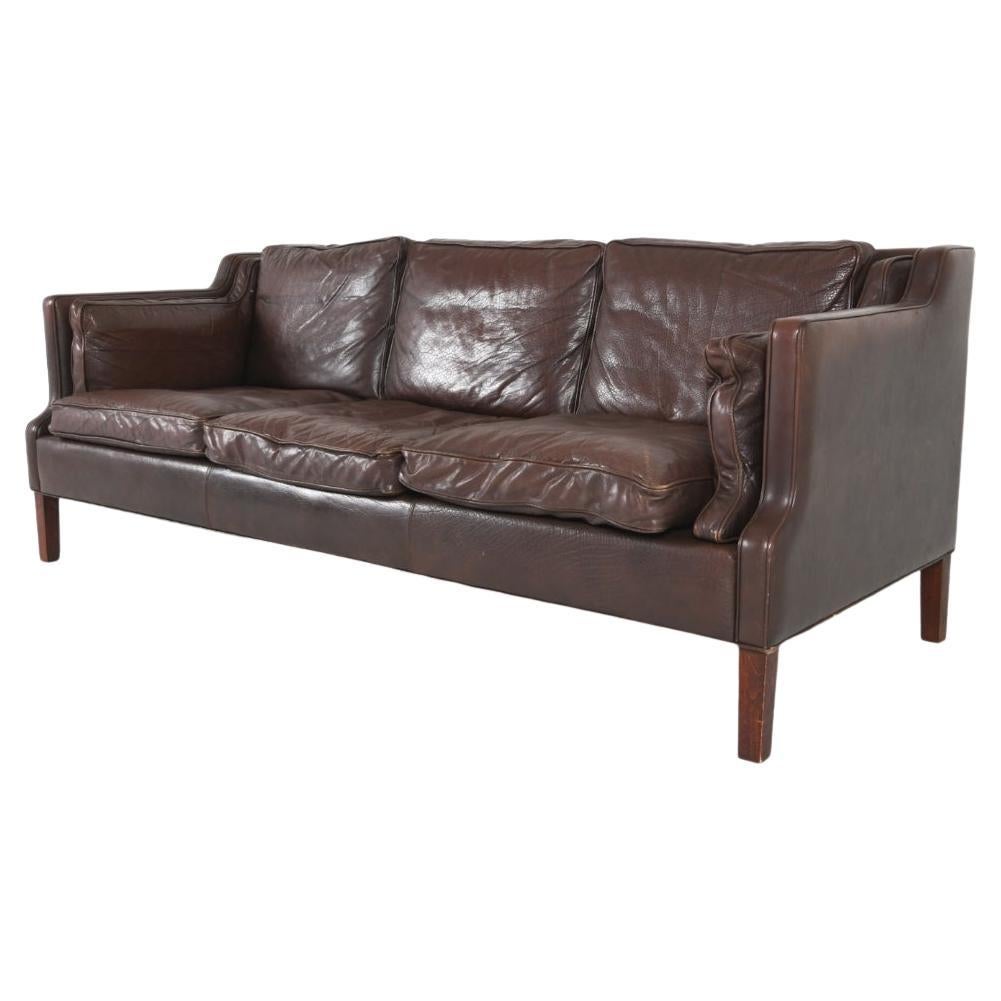 Luxurious leather sofa Mogens Hansen style. This sofa features gently sloping track arms with austere and refined silhouettes. It's finished in supple buffalo hide leather with a soft, sun faded patina that only decades can create. 
 The stained