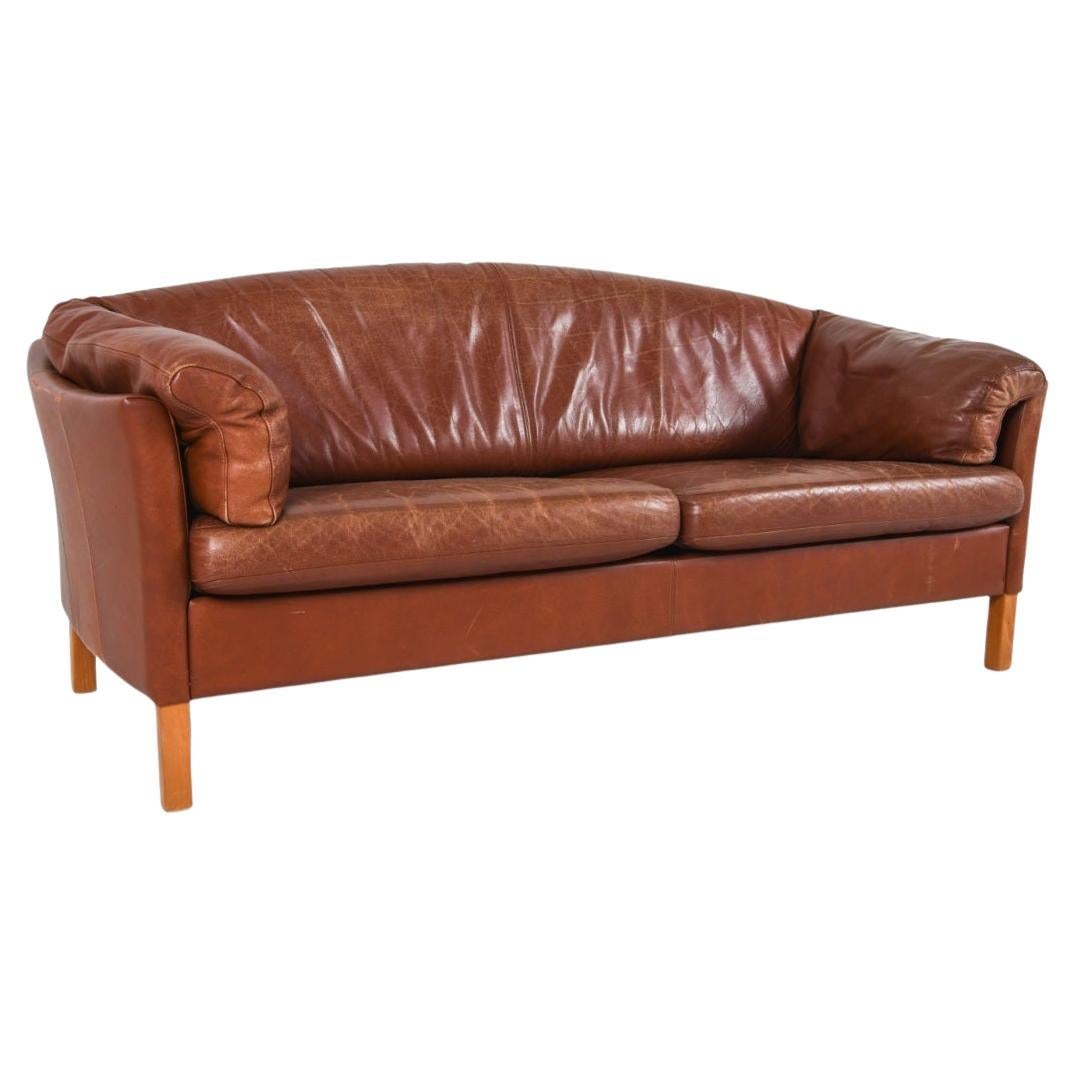 Luxurious leather sofa by Mogens Hansen, modle #535. This sofa features gently curved track arms with soft, refined silhouettes. It's finished in supple leather with a soft, sun warm patina that only time can create. 
The stained beech legs are