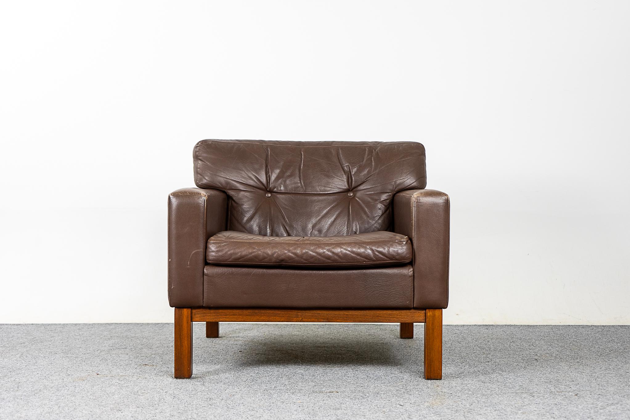 Leather and teak Danish lounge chair, circa 1960's. Simple and comfy lounge chair, original brown leather upholstery, back cushion is tufted. Solid teak base.

Please inquire for international and remote shipping rates.