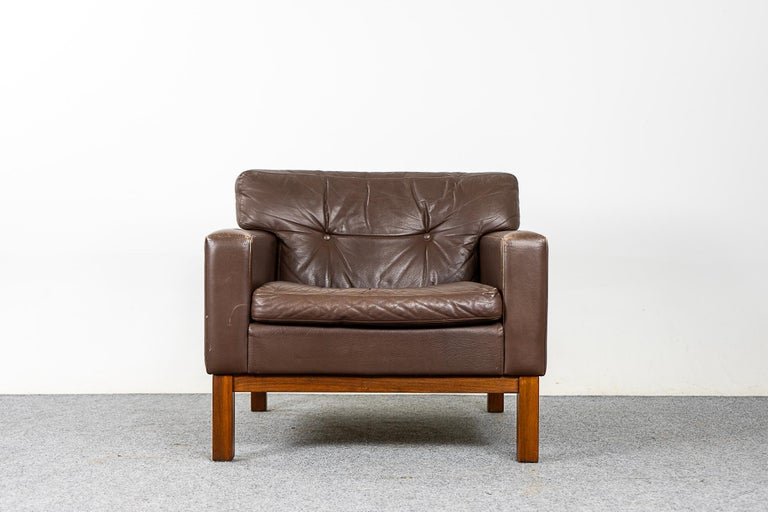Leather and teak Danish lounge chair, circa 1960's. Simple and comfy lounge chair, original brown leather upholstery, back cushion is tufted. Solid teak base.