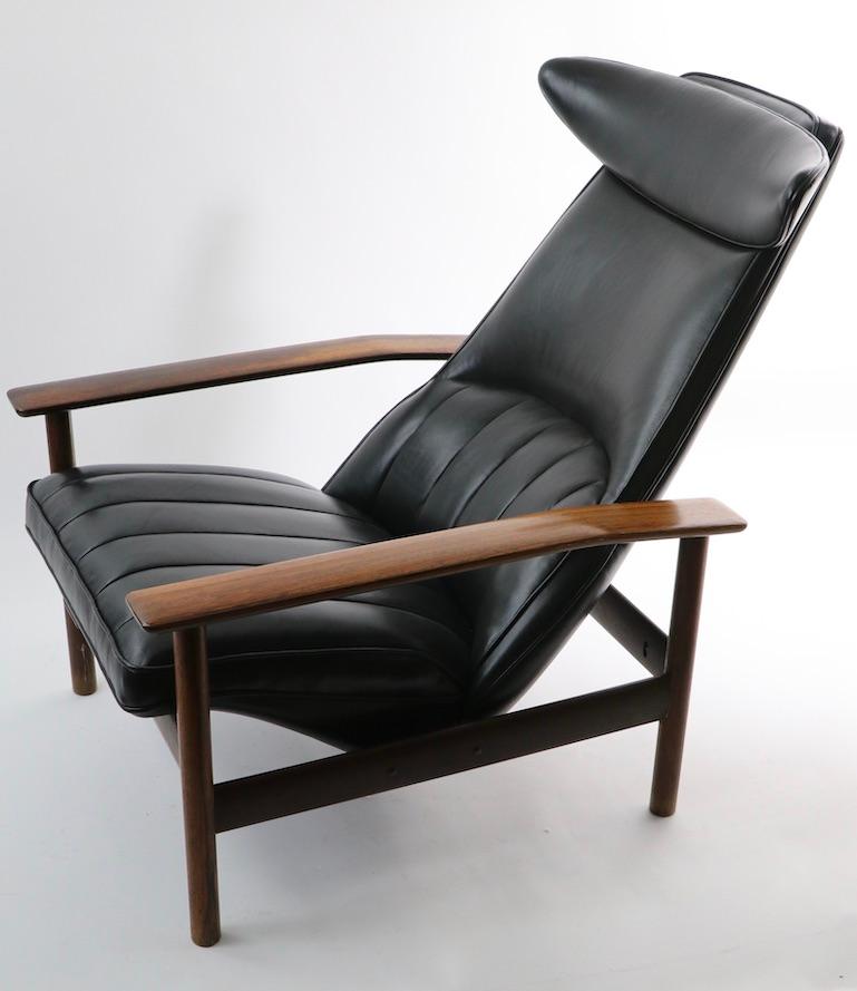 Chic, architectural and rare Danish modern lounge chair designed by Svein Dysthe for Dokka Mobler. This example has a rosewood frame, and has been professionally reupholstered to the highest standards, using top grade leather. Impressive and iconic