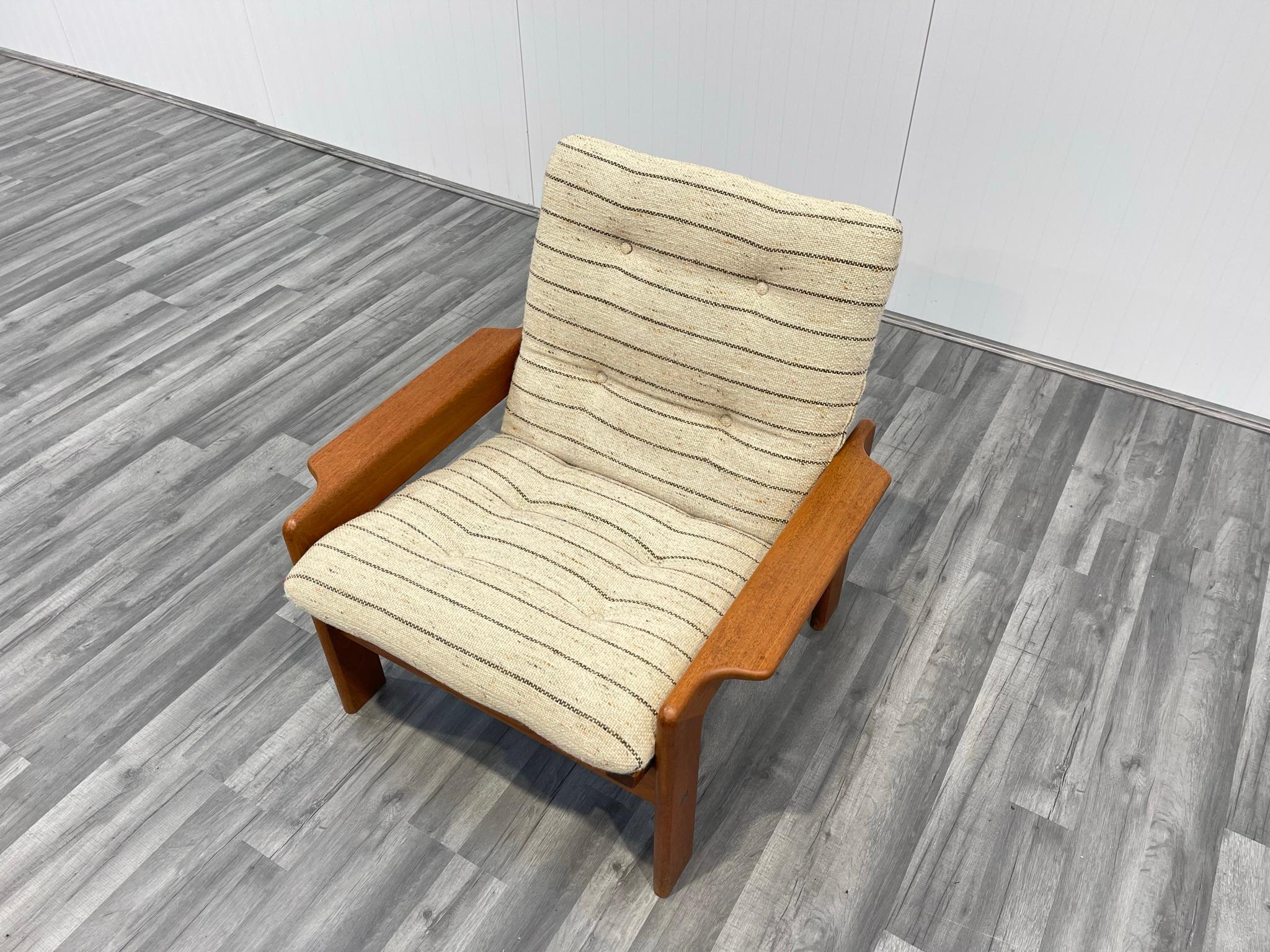 Manufactured in Denmark, this is a super stylish lounge chair in solid teak. Beautiful lines to this piece. When viewed in profile, we see a ‘triangular’ seat upon a squared frame. Look out too for the wonderfully formed armrests. Perfect for