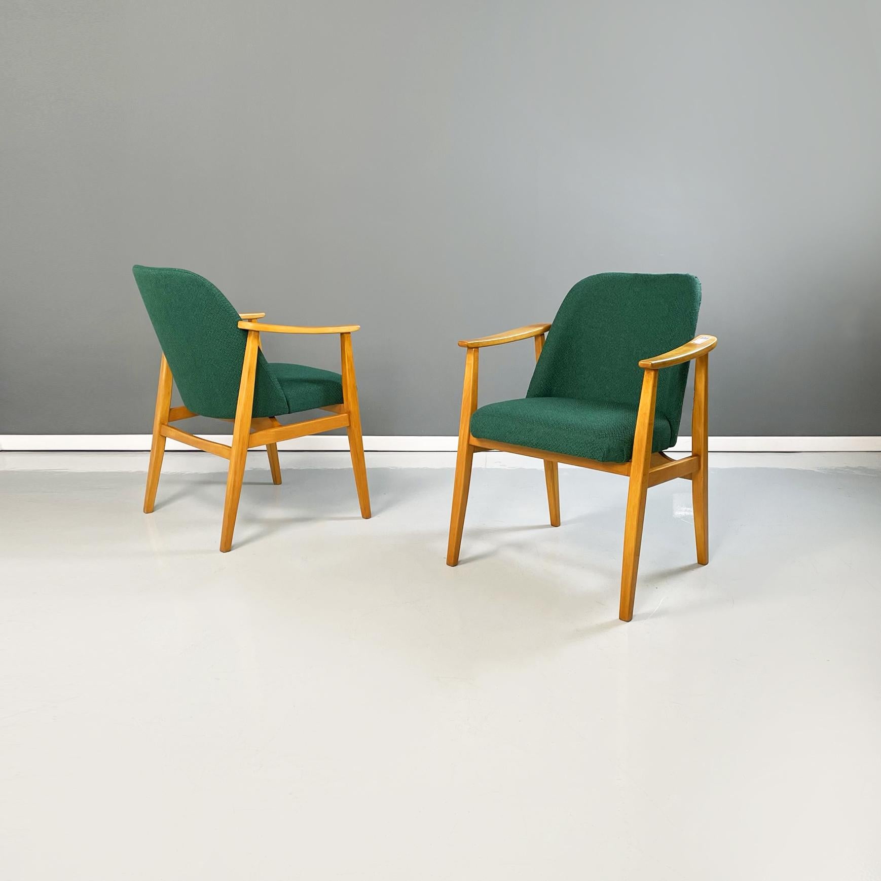 Danish Mid-Century Modern chairs in forest green fabric and wood, 1960s.
Pair of Classic and elegant armchairs with slightly curved seat and back upholstered in forest green fabric. Slightly curved wooden armrests. The structure with legs with