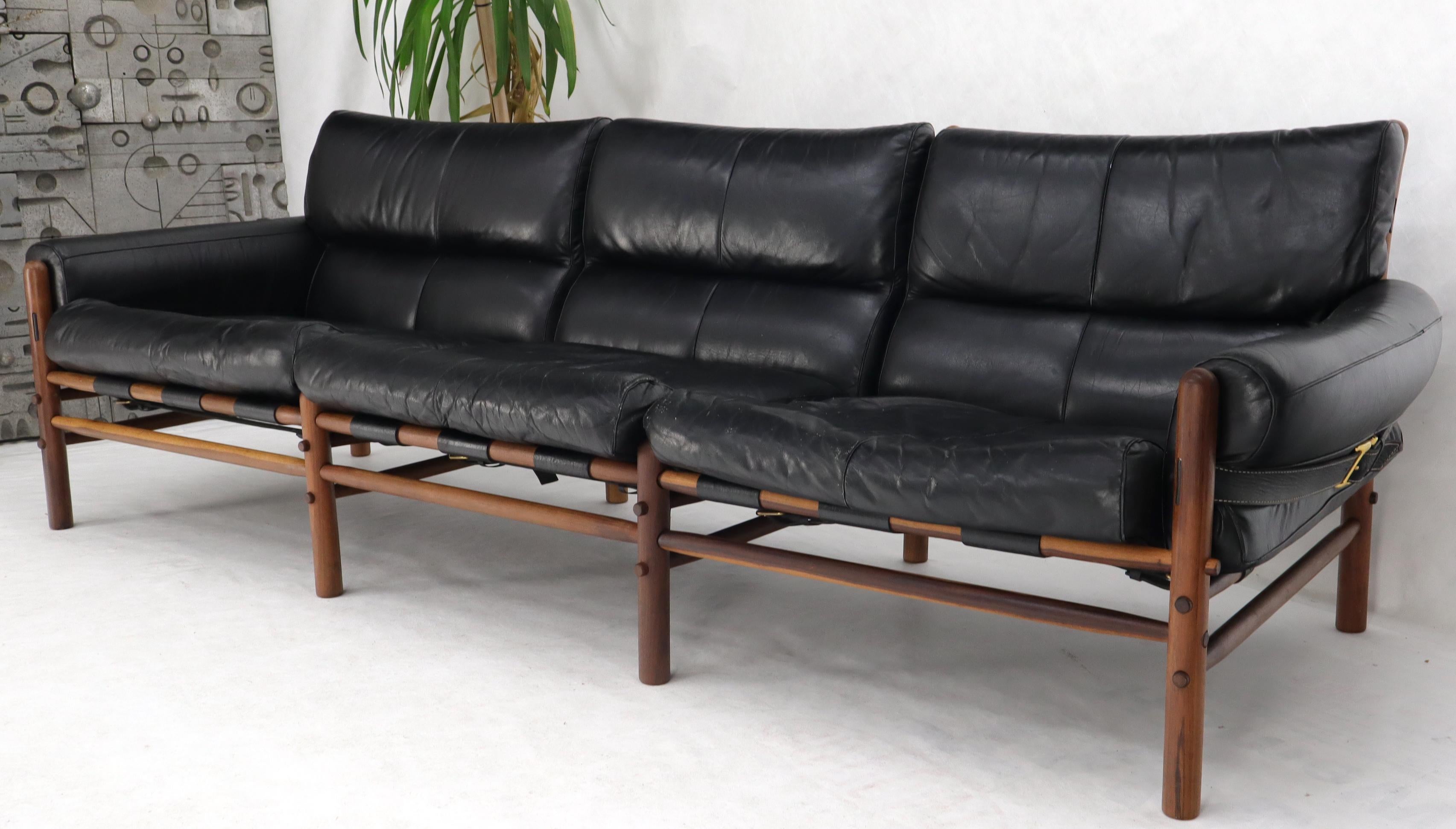 Outsranding Danish Mid-Century Modern black leather sofa teak frame by Arne Norell.