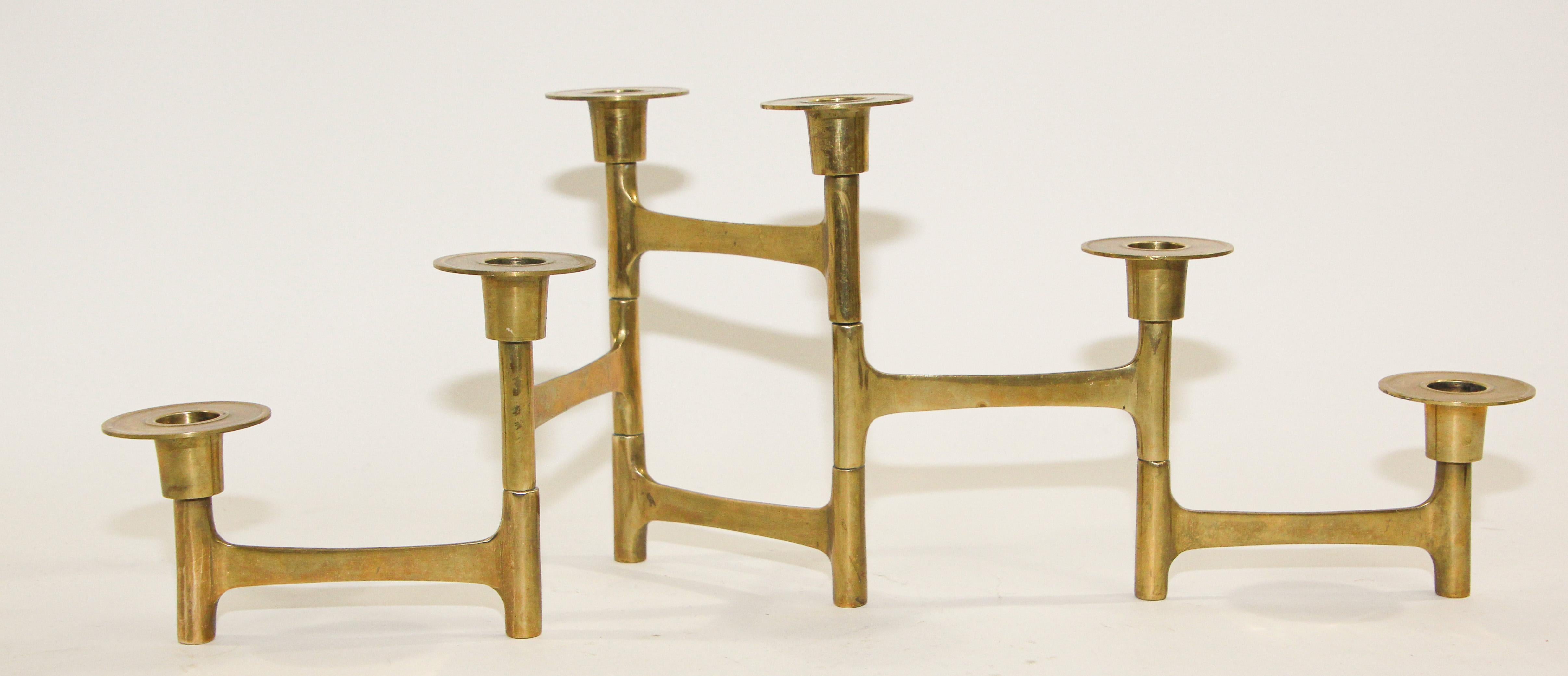 Midcentury Danish modern brass articulating candle holders.
Five articulated arms, each arm measures 4.5 inches in length, entire candleholder measures 22.5 inches when fully extended.
The taller holders measure 7 inches high while the smaller