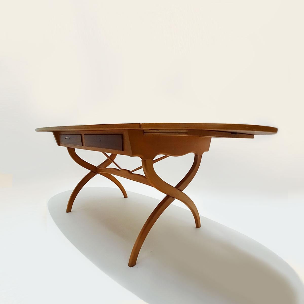 A superb vintage Danish Børge Mogensen extending drop-leaf desk in bent beechwood and teak with scissor legs and produced in 1957 by Søborg (Fredericia) Møbelfabrik.

This is an unusual desk by Mogensen that dates from the earlier part of his