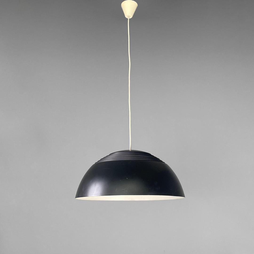Danish mid-century modern ceiling lamp by Arne Jacobsen for Louis Poulsen, 1960s
Round metal base chandelier. The lampshade is externally painted in matt black and has six circular openings in the upper part that follow the circumference. The