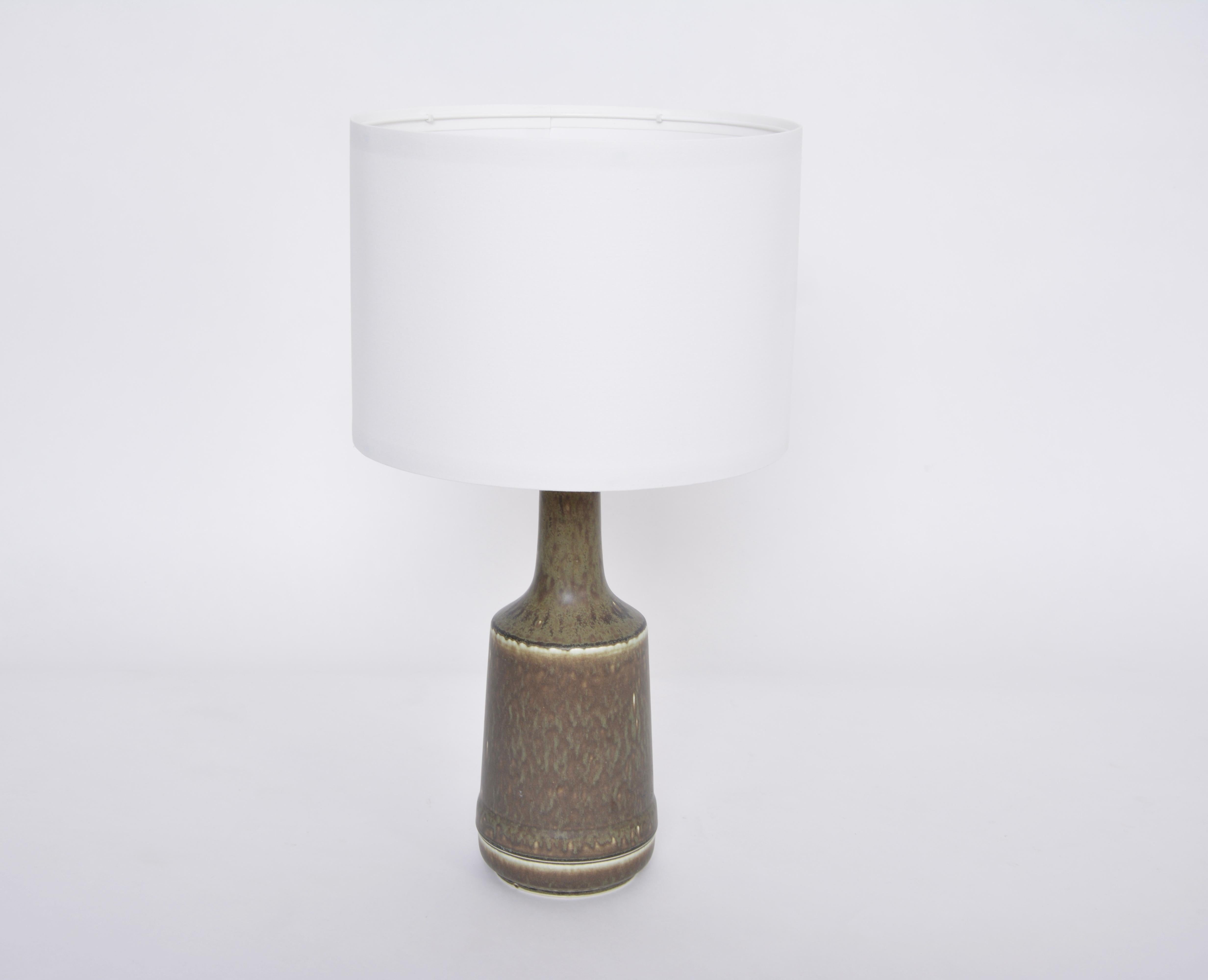 Danish Mid-Century Modern Ceramic Table Lamp by Desiree Stentoj
This lamp was produced by Danish company Desiree Stentoj probably in the 1960s. The lamp is made of glazed stoneware. It has a beautiful glazing in tones of dark green. The base