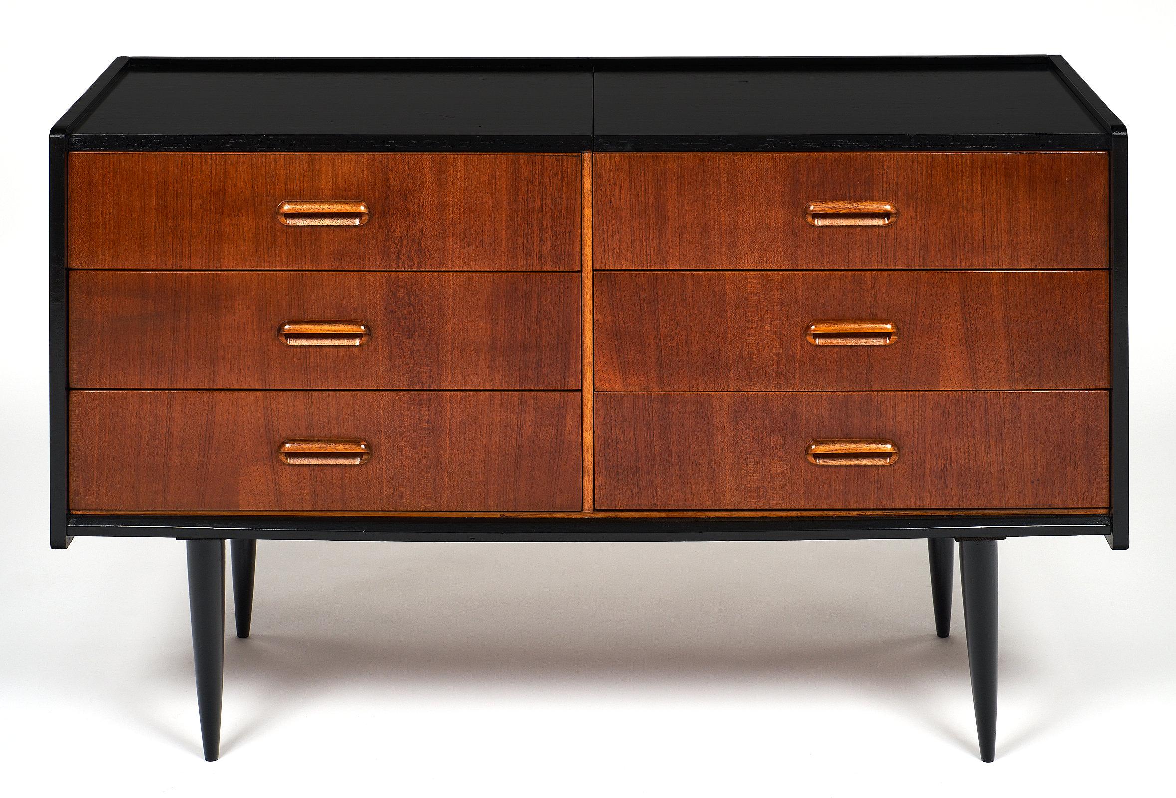 A fine Mid-Century Modern Danish chest with six drawers, one of which is a drop front. We loved the perfect proportions, teak wood, and satin finish. The base and top have been ebonized for a striking contrast.