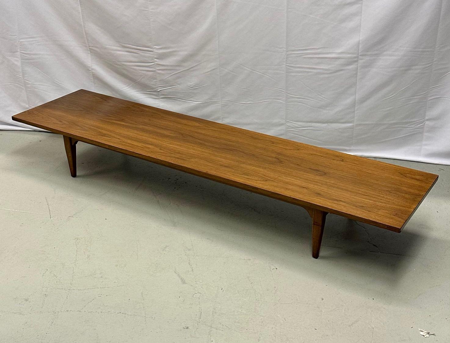 Danish Mid-Century Modern solid teak narrow low / coffee table, 1950s.
A six foot long and narrow Mid-Century Modern coffee table having a solid teak top and base sitting on 4 recessed legs. Designed by and unknown Danish designer. 
Measures: 10 H