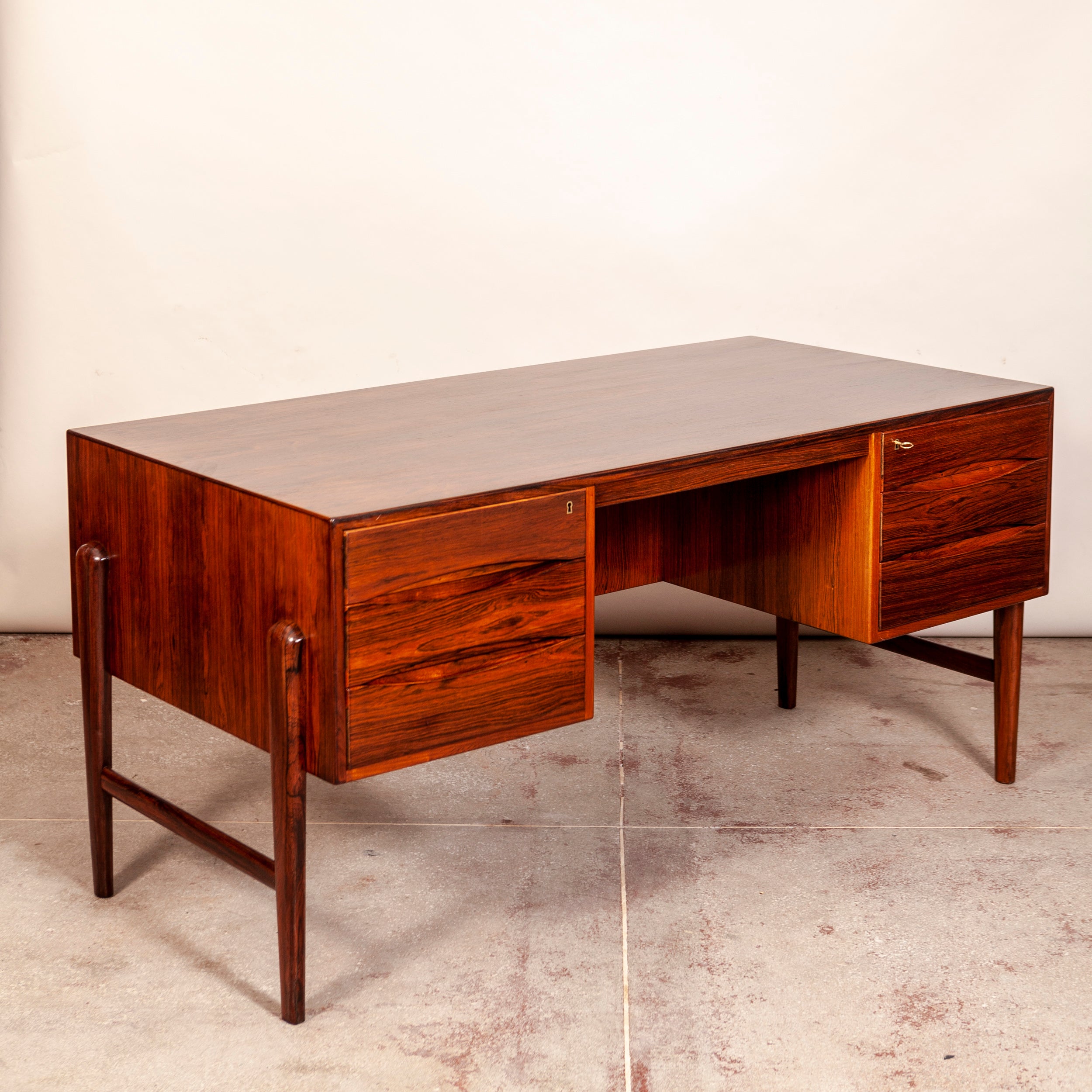 This beautifully designed & proportioned desk is constructed in premium Brazilian Rosewood which features beautiful grain all around.

The drawer fronts display perfect form and function while the sides are attached to the insides of the drawer