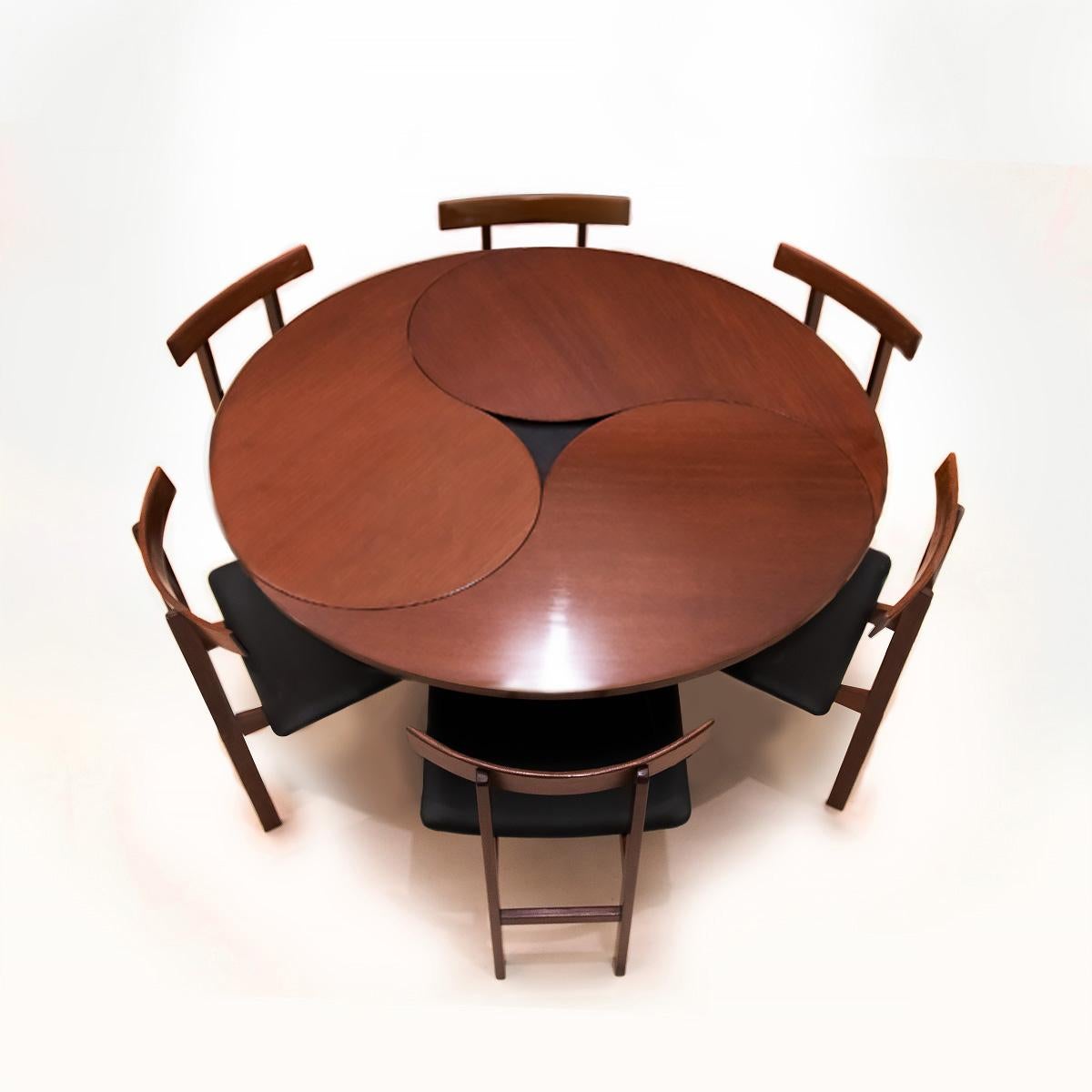 An extraordinary Danish mid century vintage teak and wenge Model 550 space saving dining table designed by Ole Gjerløv-Knudsen and Torben Lind matched to a set of 6 Inger Klingenberg Model 193 chairs. 

This vintage Danish dining set is a perfect