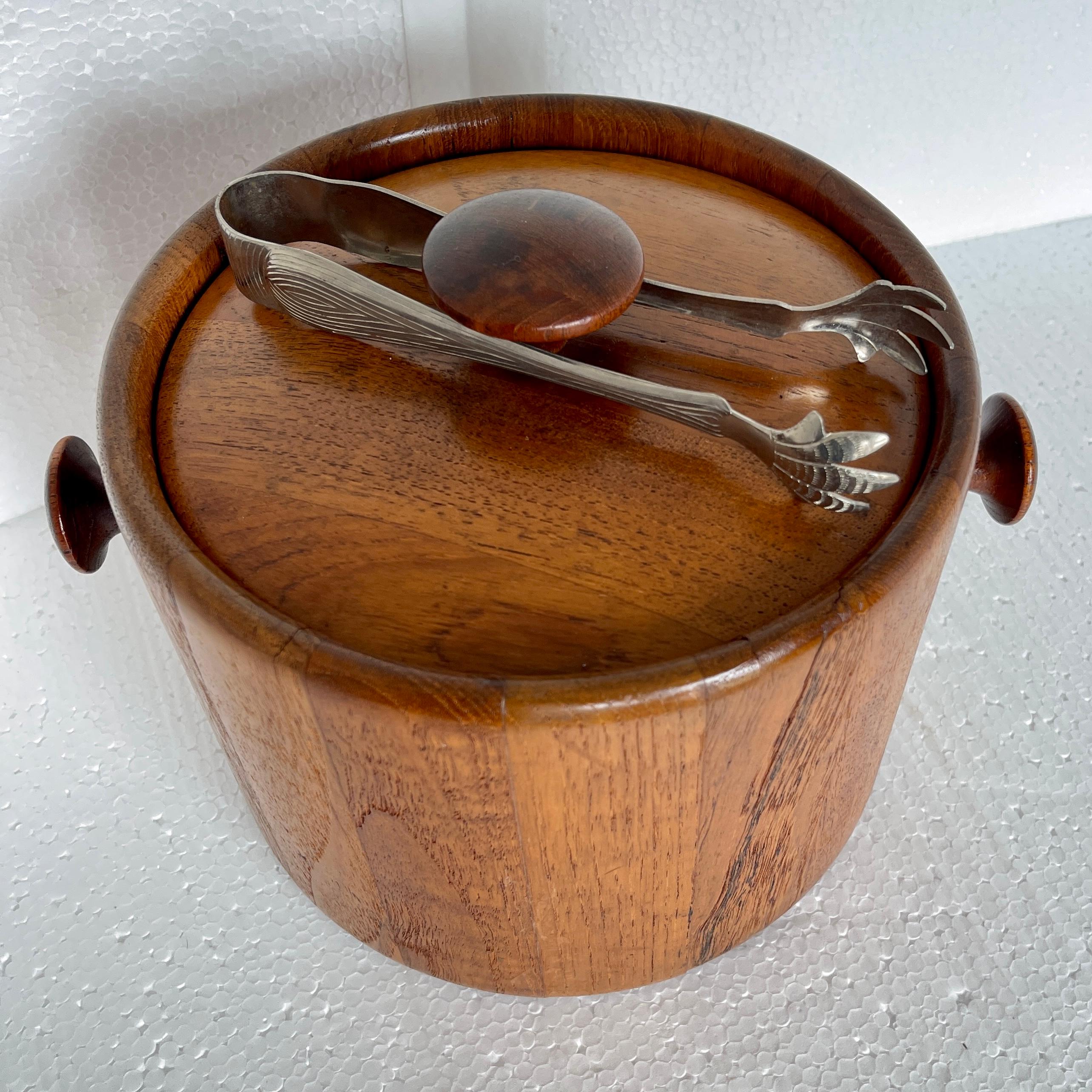 Vintage Danish Mid-Century Modern ice bucket, marked Digsmed. This beautifully crafted teak ice bucket dating from the 1960's is a classic example of Danish simplicity.  The teak is in very good condition as is the interior; perfect complement for