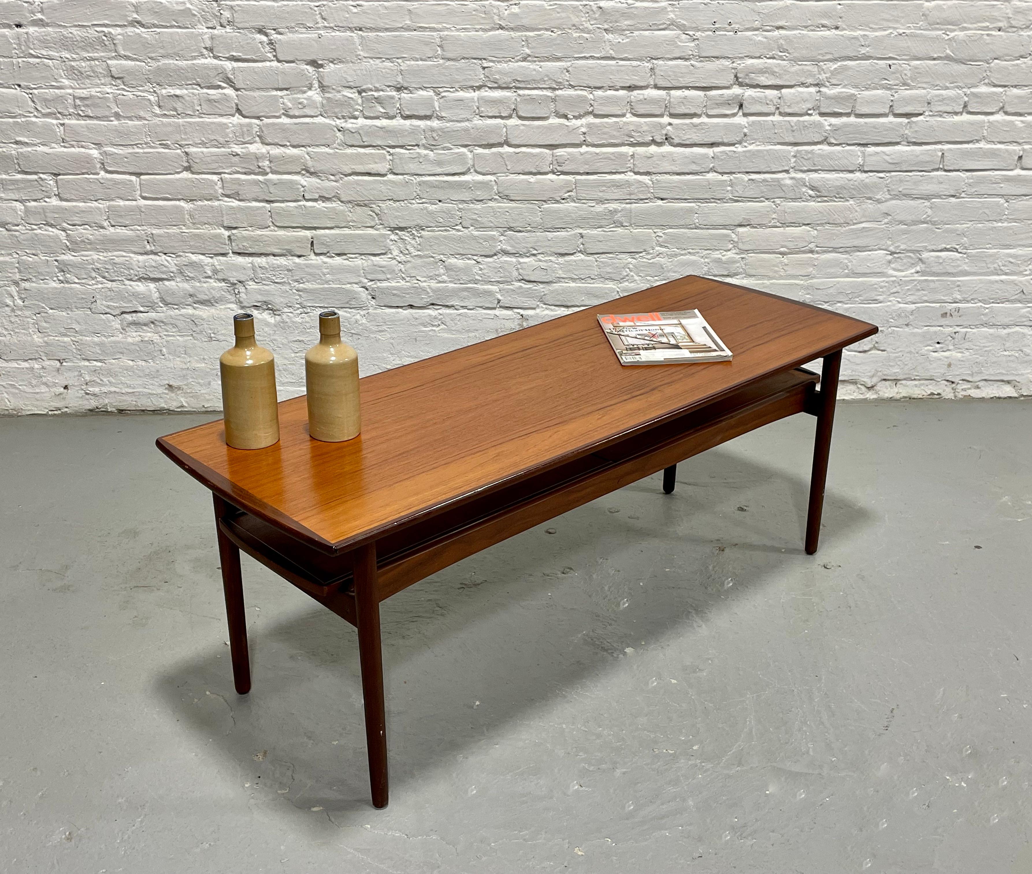 A rare and versatile coffee table designed and crafted in Denmark by Bramin in the 1960s. The piece has been newly refinished, highlighting the richness of the teak wood and its striking grain. Elegant in form, it stands on long, tapered legs that