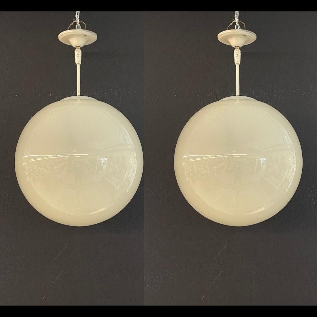 Danish Mid Century Modern, Globe Pendants, Opal White Glass, Metal, 1960s

A pair of Danish vintage Circular Globe Pendants or Chandeliers. Each has a canopy leading to white metal adjustable rods supporting frosted white glass spheres.
The pair in