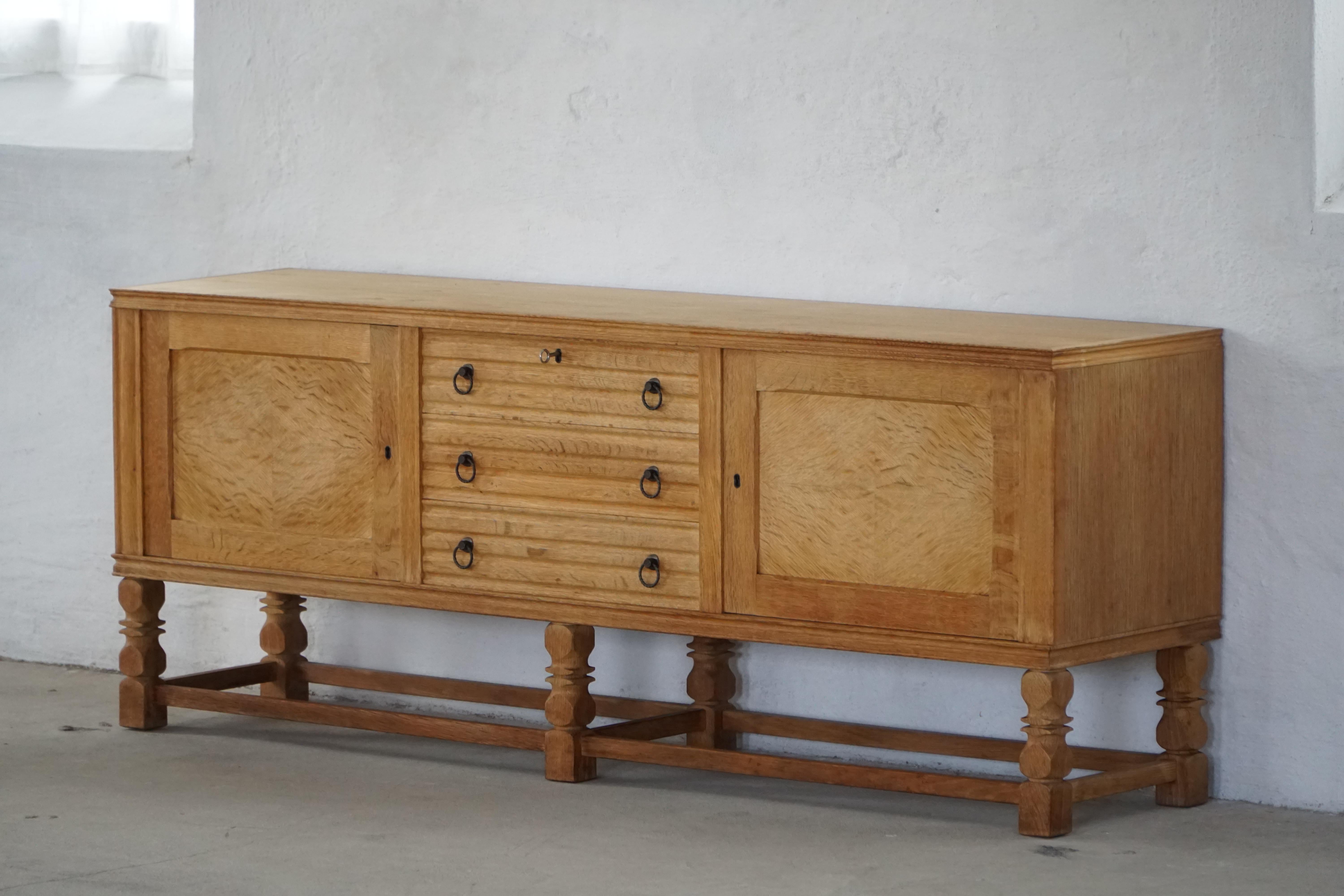 An elegant Danish Modern sideboard from the 1950s-60s, crafted in beautifully figured oak with a warm patina. The piece reflects the refined craftsmanship and understated sophistication characteristic of Danish furniture design from the period.

The