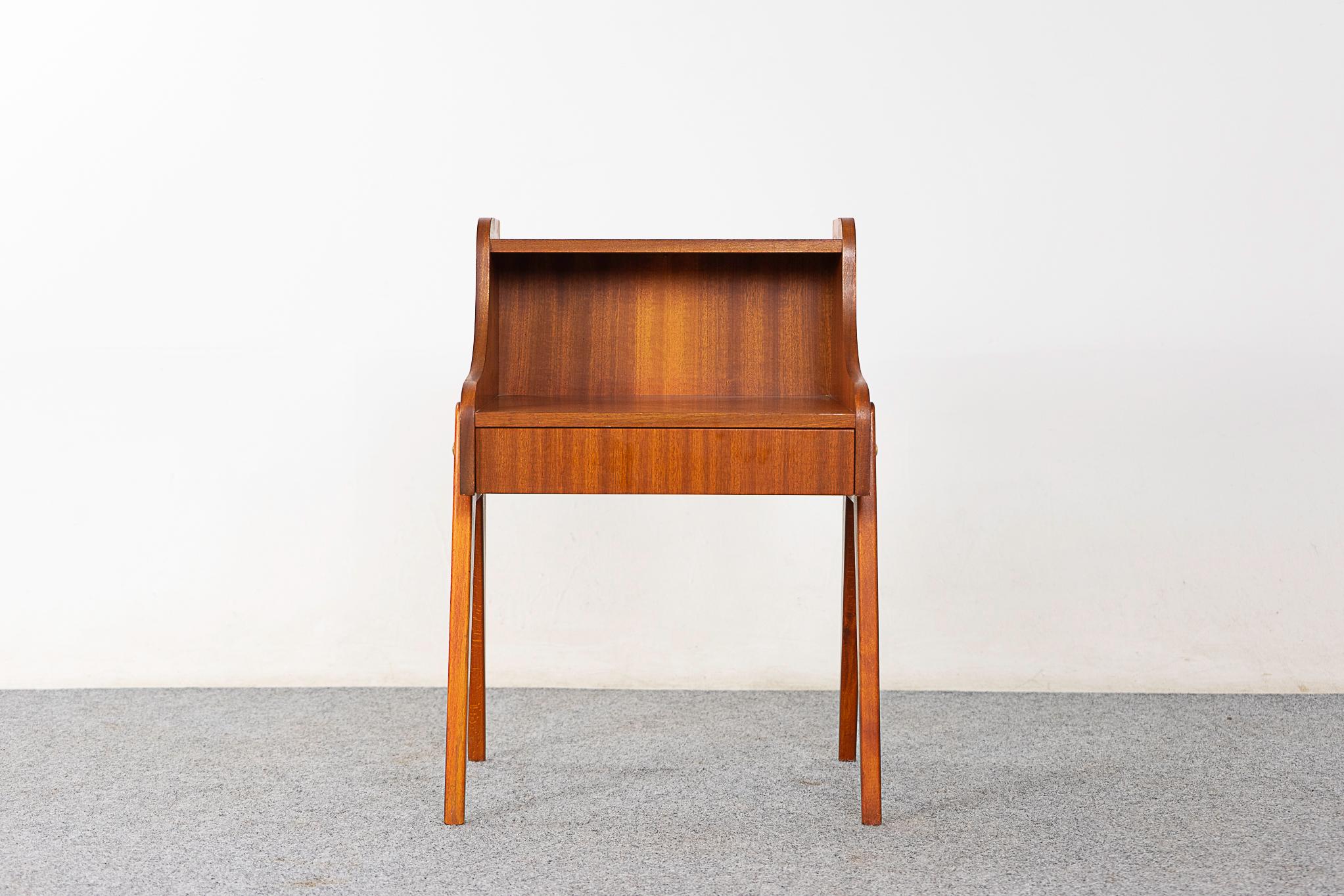 Mahogany mid-centruy bedside table, circa 1960's. Beautifully veneered with slender splayed legs and sleek drawer.

Unrestored item with option to purchase in restored condition for an additional $150 USD. Restoration includes: repairs, sanding,