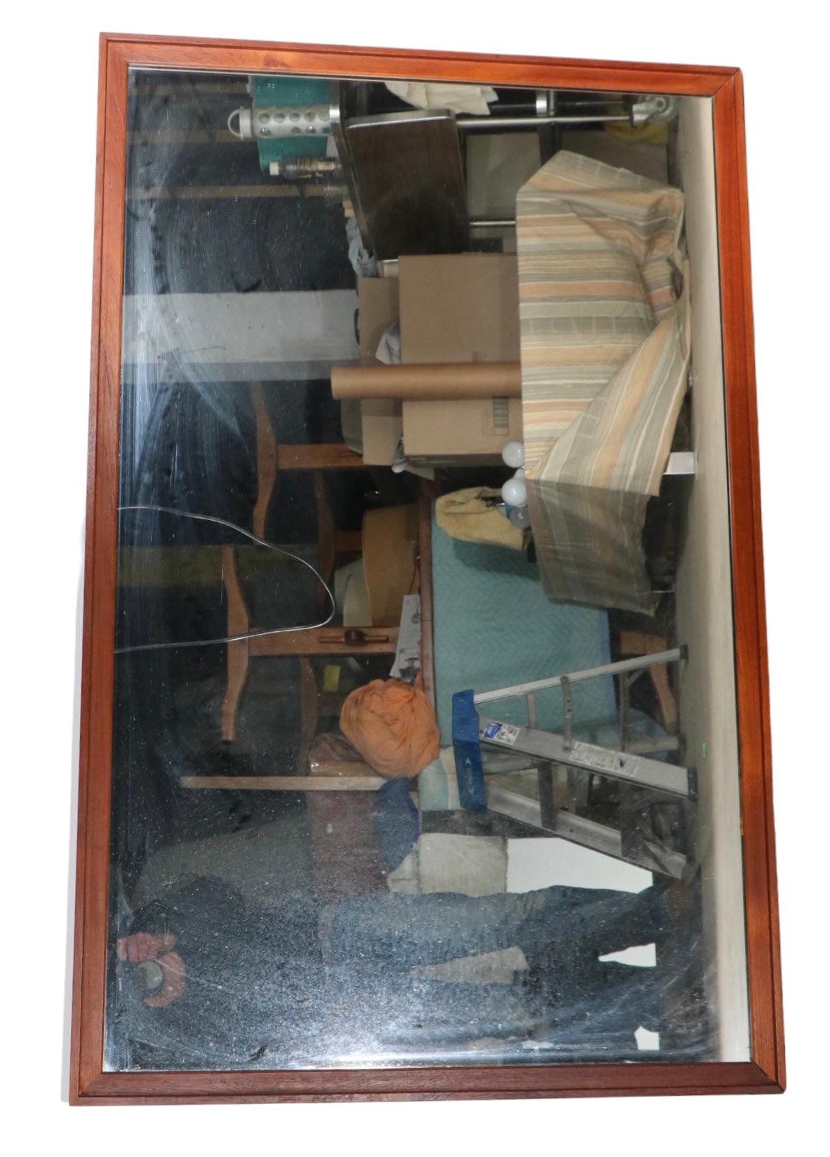 Sophisticated architectural wall mirror by noted danish maker, Falster Mobelfabrik. The solid wood frame surrounds a bright plate glass mirror, this example is in very fine, original, clean and ready to install condition. The mirror  can hang either