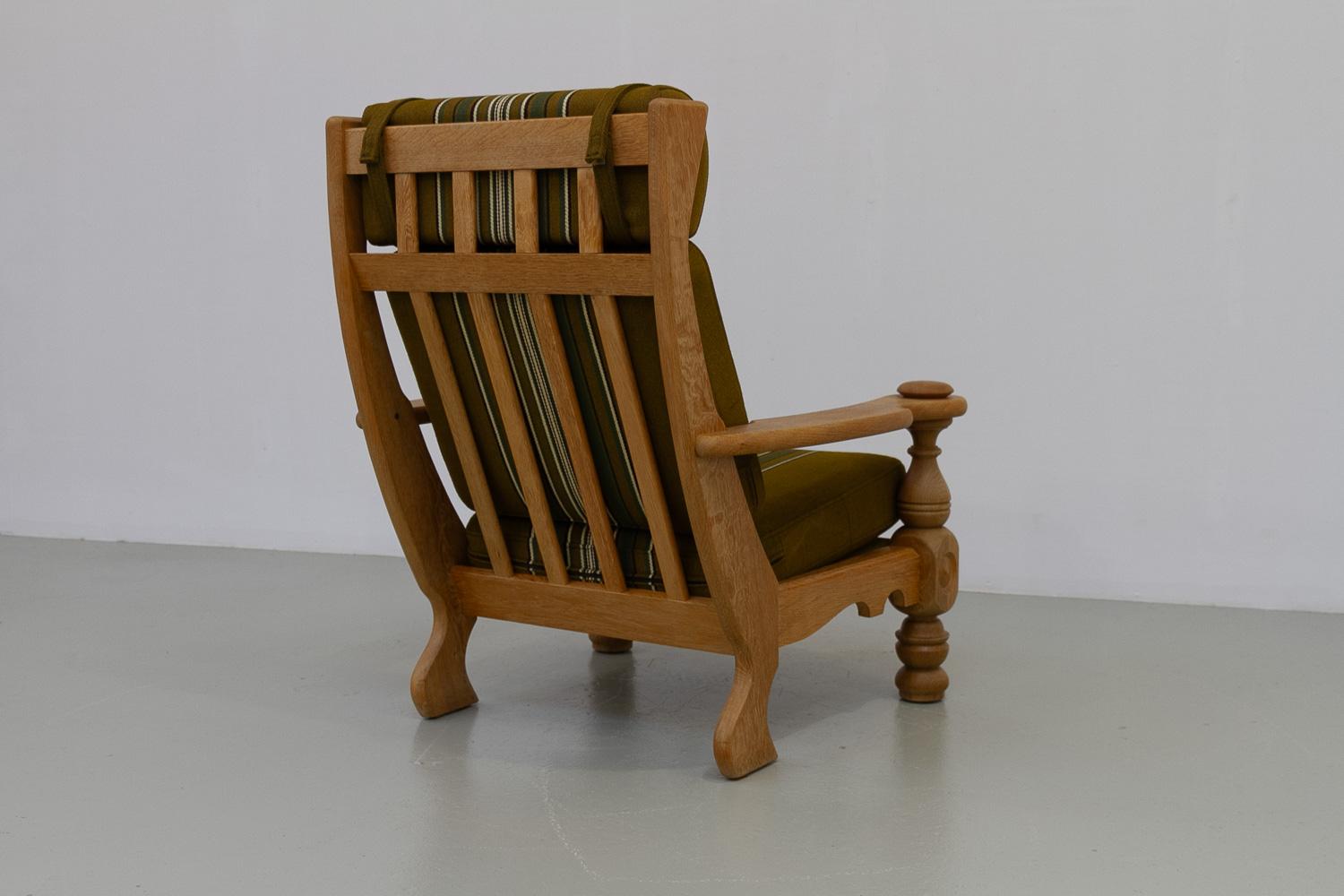 Danish Mid-Century Modern Oak High Back Lounge Chair in Kjærnulf Style, 1960s.

Beautiful Scandinavian Mid-Century Modern rustic highback lounge chair in solid Nordic white oak and original green striped wool fabric on spring cushions.
Manufactured