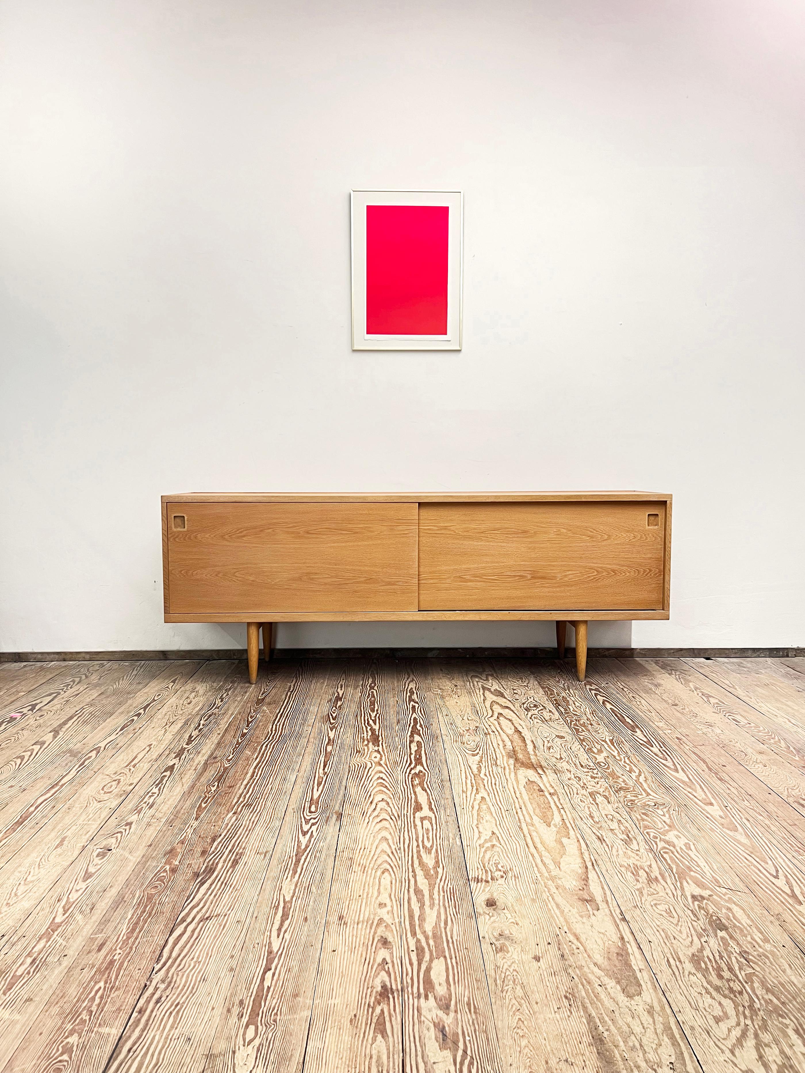 Dimensions: 210x48x80 cm (Width x Depth x Height)

This Scandinavian design sideboard or TV console was designed in the 1950s by Niels O. Møller and manufactured by J.L. Møllers in Denmark.

The mid-century Credenza showcases exquisite Danish design