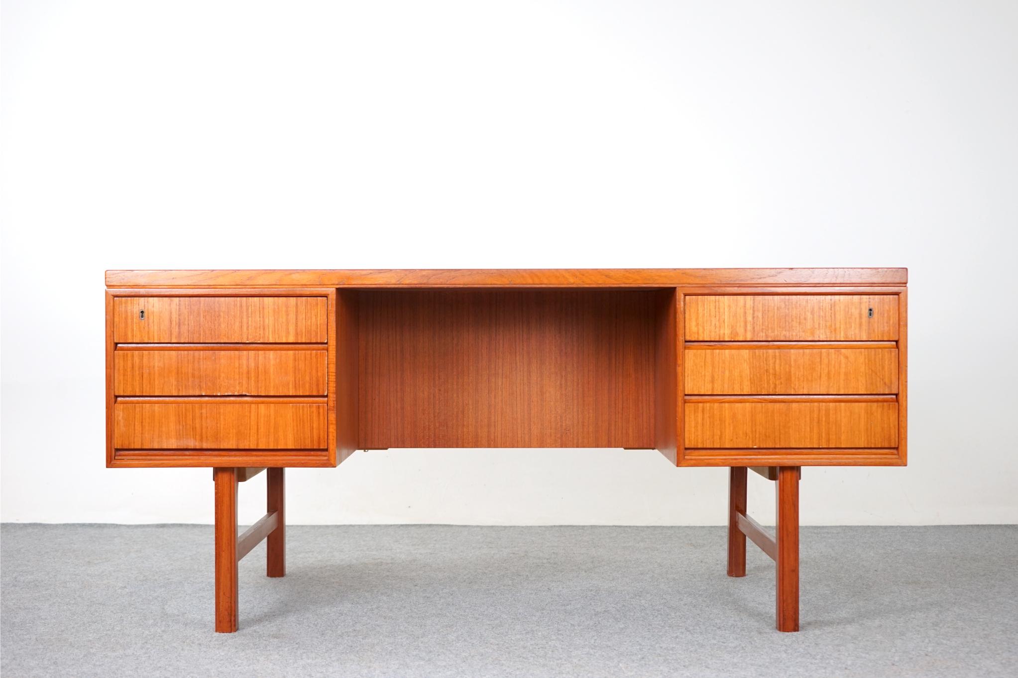 Teak Scandinavian Model 76 desk by Omann Jun, circa 1970's. A clean linear design that will compliment any decor. Writing desk is finished on both sides, if placed in the center of a room it will look fantastic from every angle, Integrated sleek