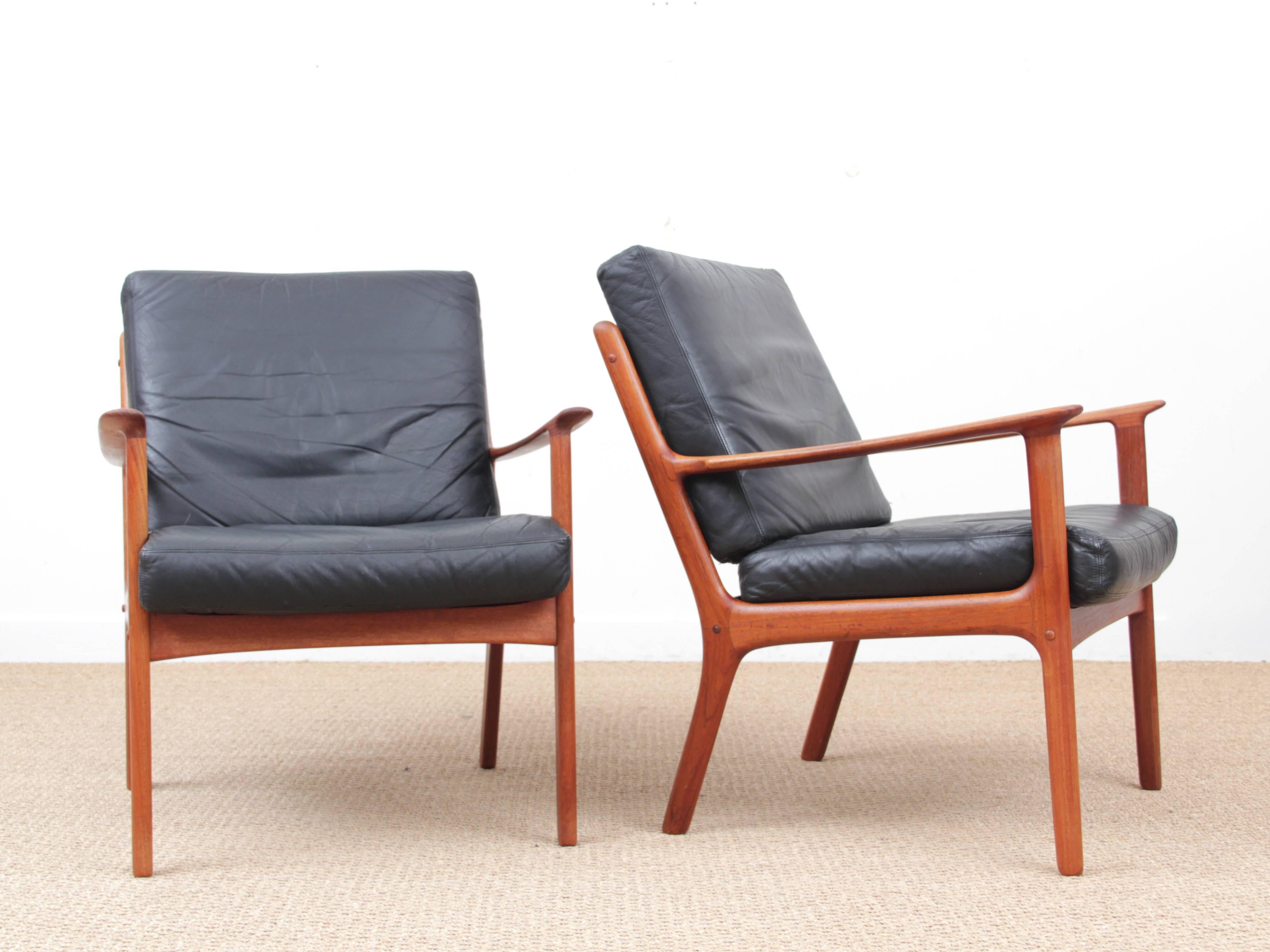 Danish Mid-Century Modern pair of armchairs by Ole Wanscher for Paul Jepesen in solid teak. Original black leather cushions. Referenced by the Design Museum Danmark under number RP02694.