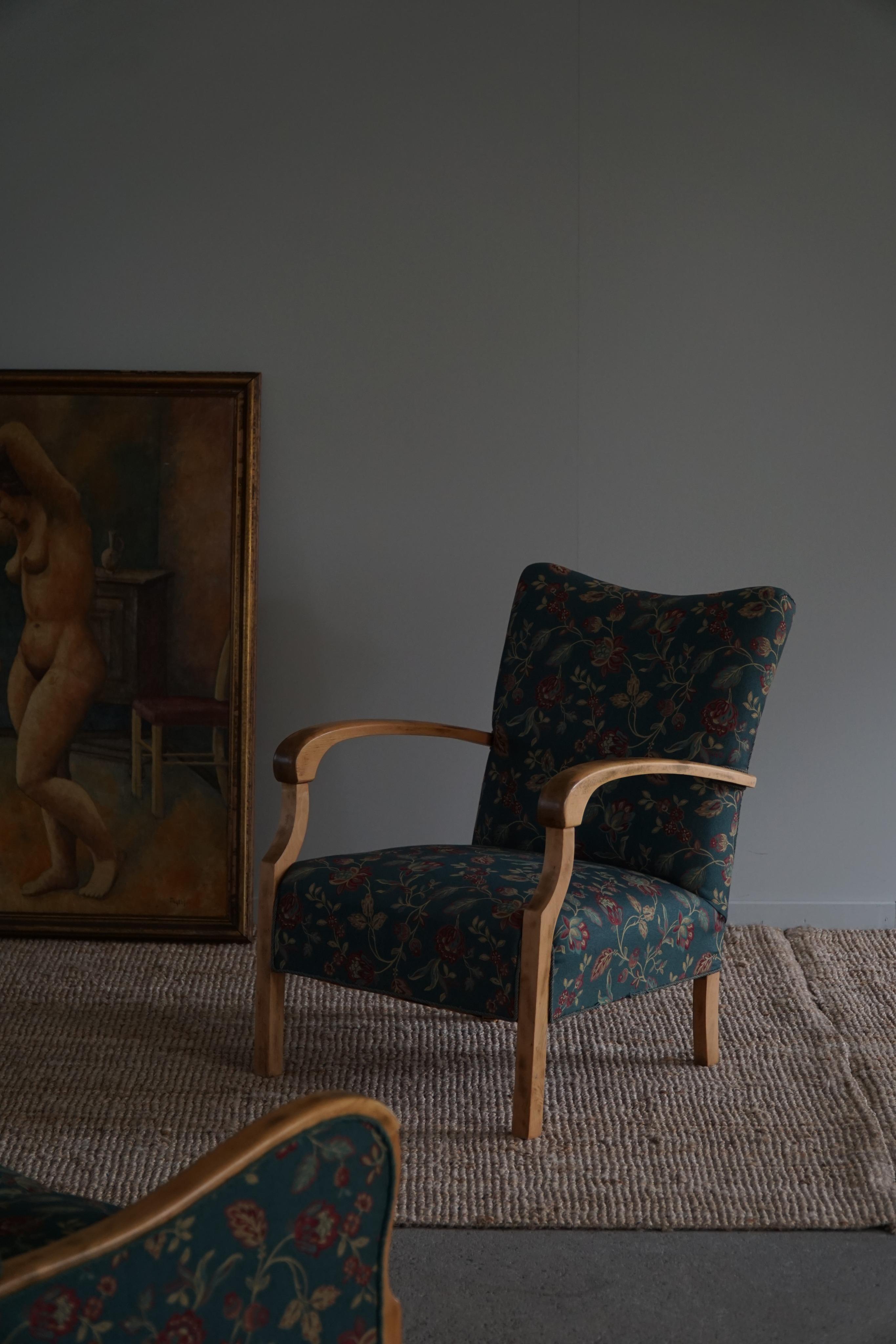 A timeless pair of Danish modern lounge chairs in beech and the original colorful flower fabric. Crafted by a Danish cabinetmaker in the 1960s.

These fine lounge chairs embodies the essence of Danish design, combining sleek lines, organic forms,