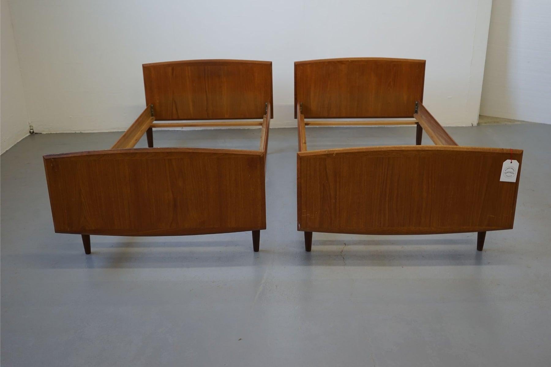 Teak pair of single twin beds, circa 1960's. Low profile design means all you need is a mattress, no box-spring or foundation required!

***Note European mattress size required 33.5