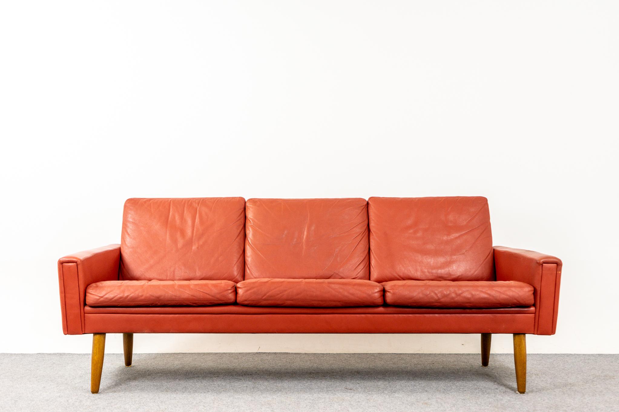 Leather & oak Danish Modern three seat sofa, circa 1960's. Original leather is soft and supple while also being durable to ensure years of use and enjoyment. Sharp modern lines and contrasting conical solid removable oak legs.

Make your living room