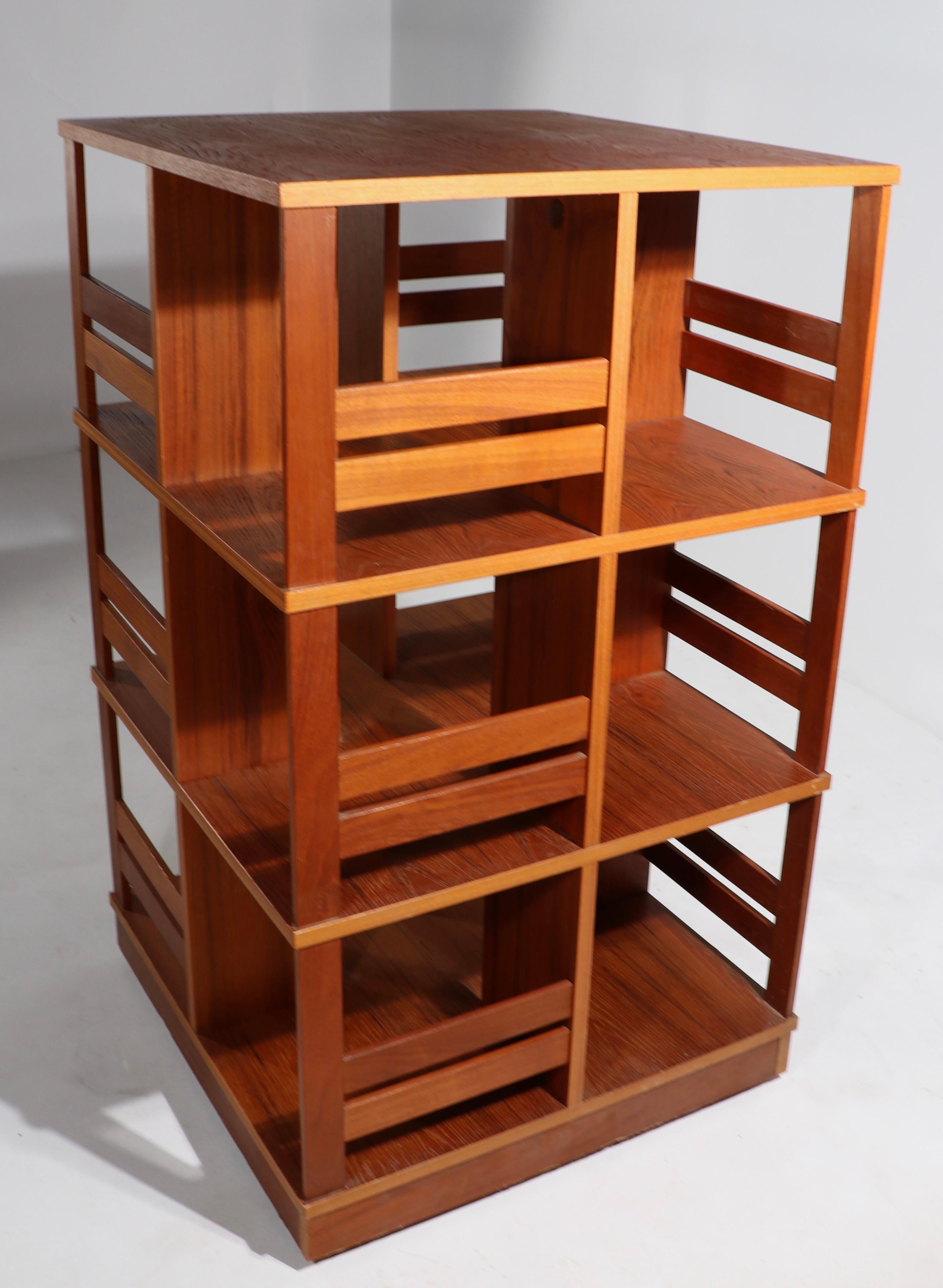 Incredible architectural scale revolving bookcase in teak, and teak veneer, executed in the Danish Modern style circa 1960's. We have 2 matching bookcases available - unusual and rare opportunity to purchase a matching pair, perfect for a large