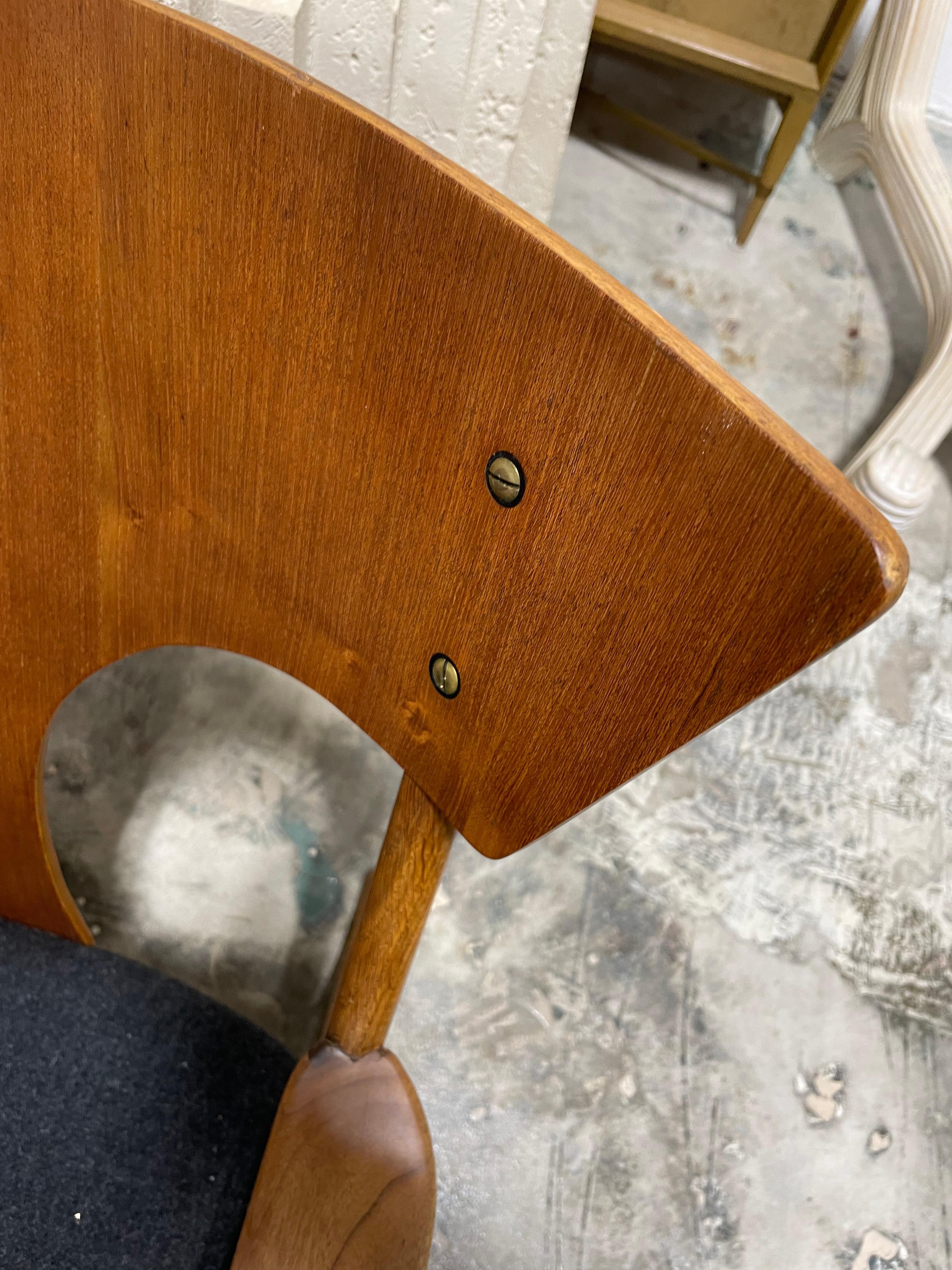 Rare Mid-Century Modern rocking chair. Made of teak and oak. Dark gray fabric on cushion.