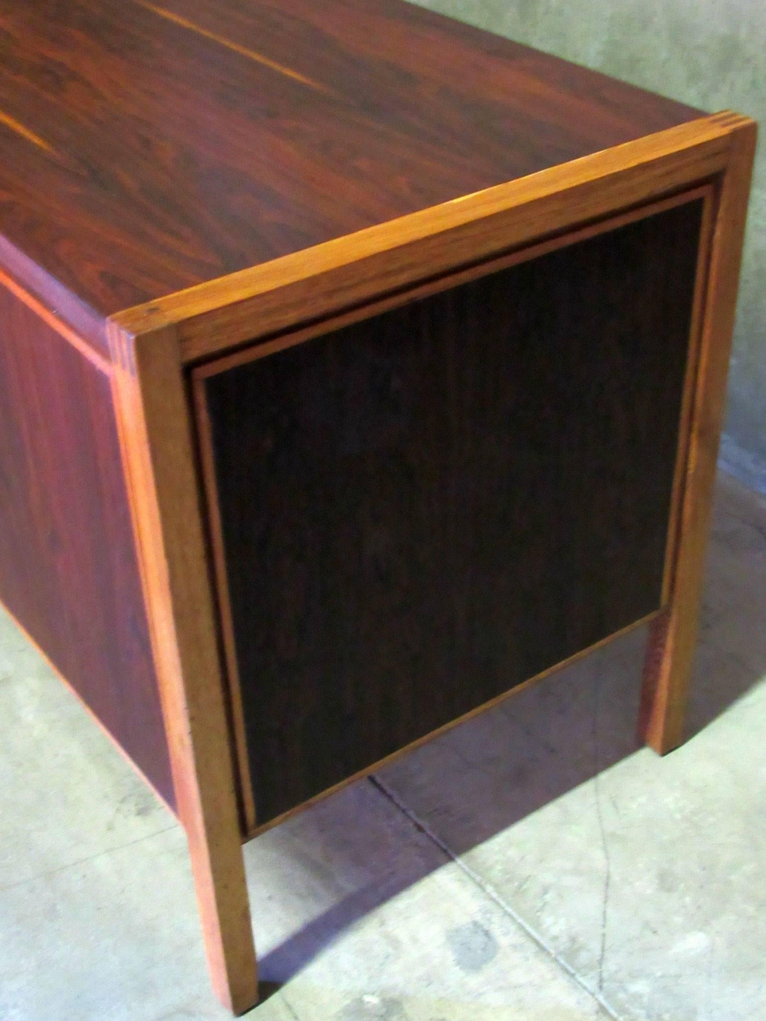 1960s Jacaranda, Rosewood & Teak Mid-Century Modern Desk from Columbia, South America.   Three teal drawers on the right have carved finger handles that inset into the face of the drawers.  The front and sides of the desk are made of Rosewood
