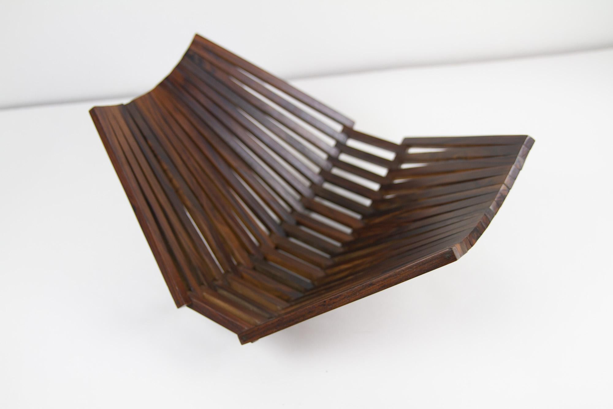 Danish Mid-Century Modern Rosewood Basket, 1960s.
Vintage Danish foldable fruit basket in solid Palisander. Made in Denmark in the 1960s. This flexible Rosewood bowl can be used as a basket or as a decorative object. When folded out it measures 40