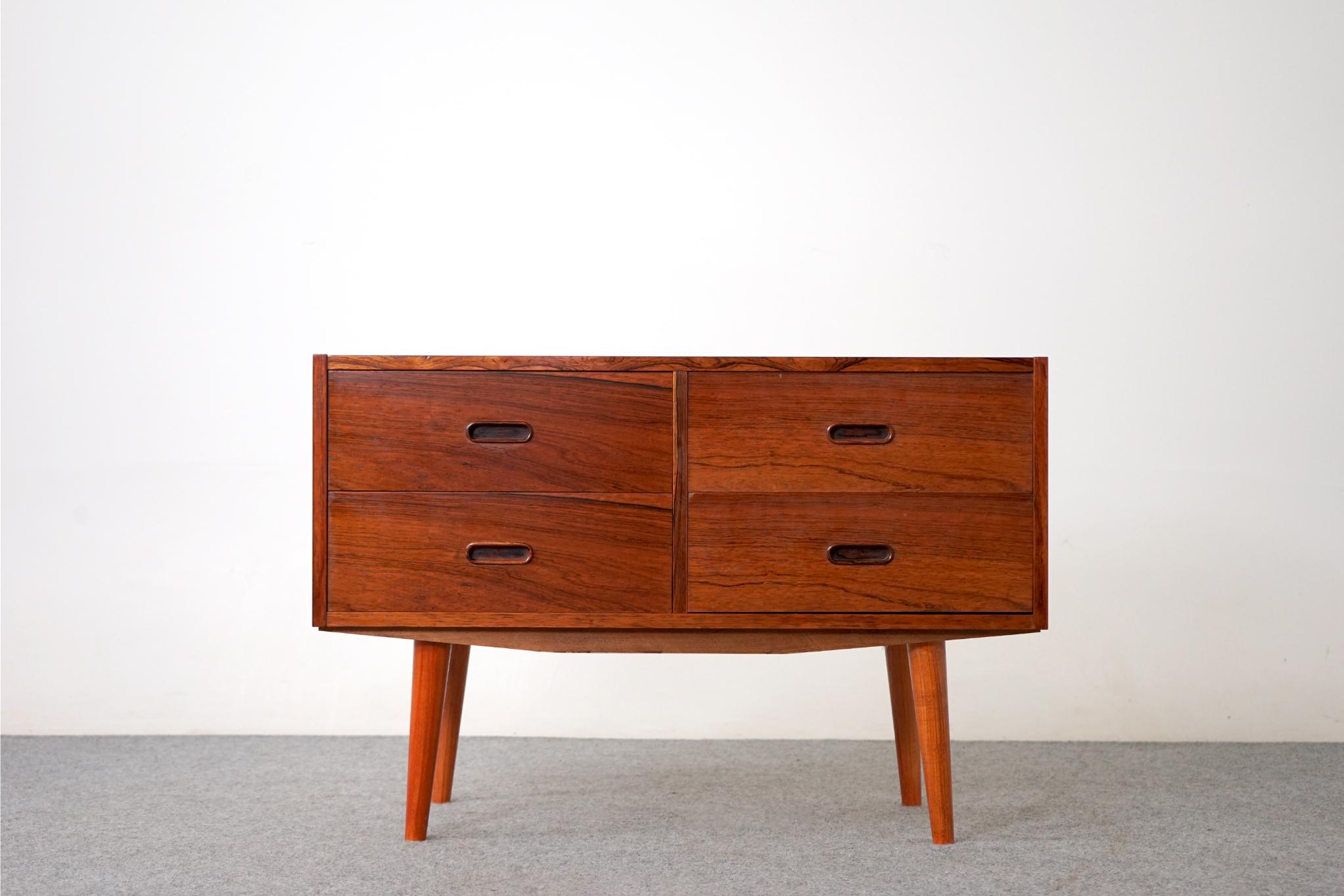 Rosewood Scandinavian dresser circa 1960's. Integrated, horizontal drawer pulls make opening and closing the drawers a breeze. This four drawer dresser features solid wood edging with stunning veneer on all drawer faces and dovetail construction.
