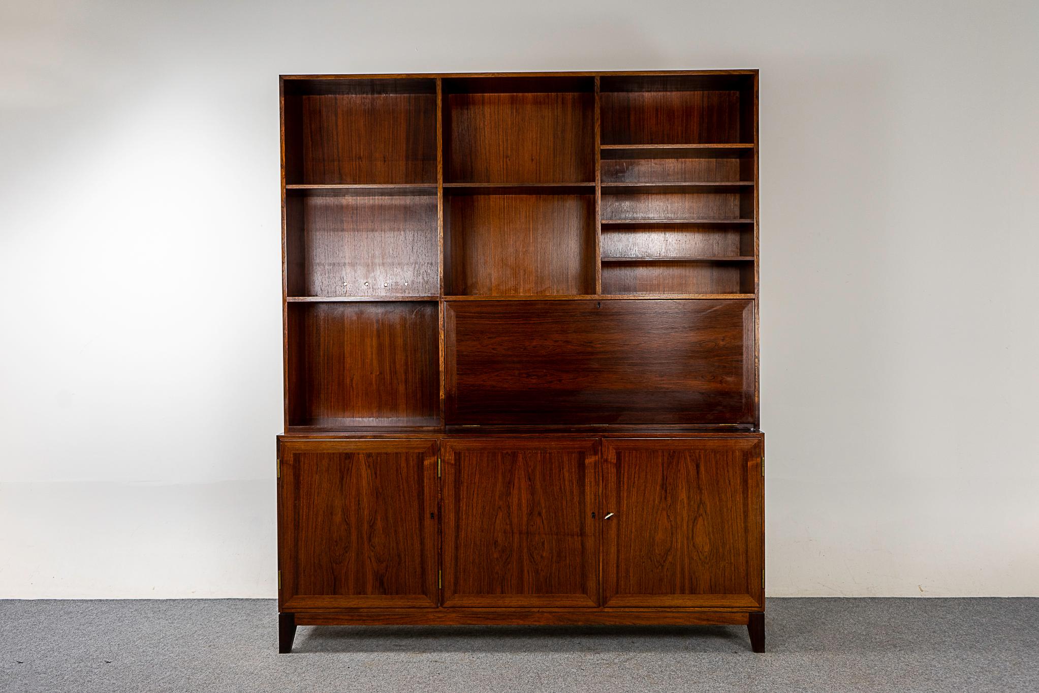 Danish rosewood bookcase cabinet by Kai Winding, circa 1960's. Highly functional design features open shelving, a drop down desk with fitted interior and lower storage with exterior doors. Danish Furniture Makers' control stamp intact.

Please