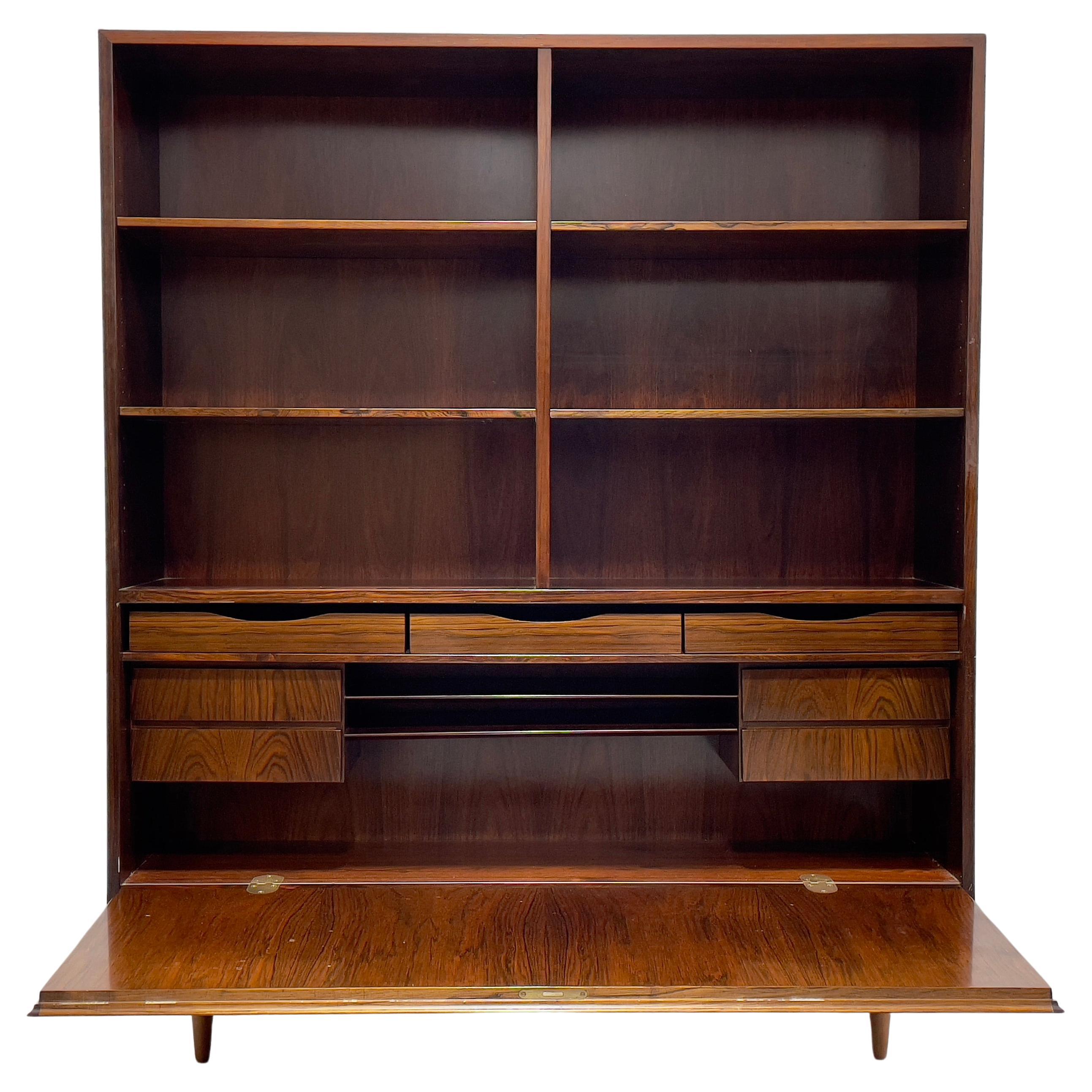 Exquisite Mid Century Modern ROSEWOOD bookcase / China Cabinet, c. 1960's. This stunning piece features 6 shelving areas in the upper area and all shelves are removable and adjustable. The lower area unlocks (yes, we have the original key!) to
