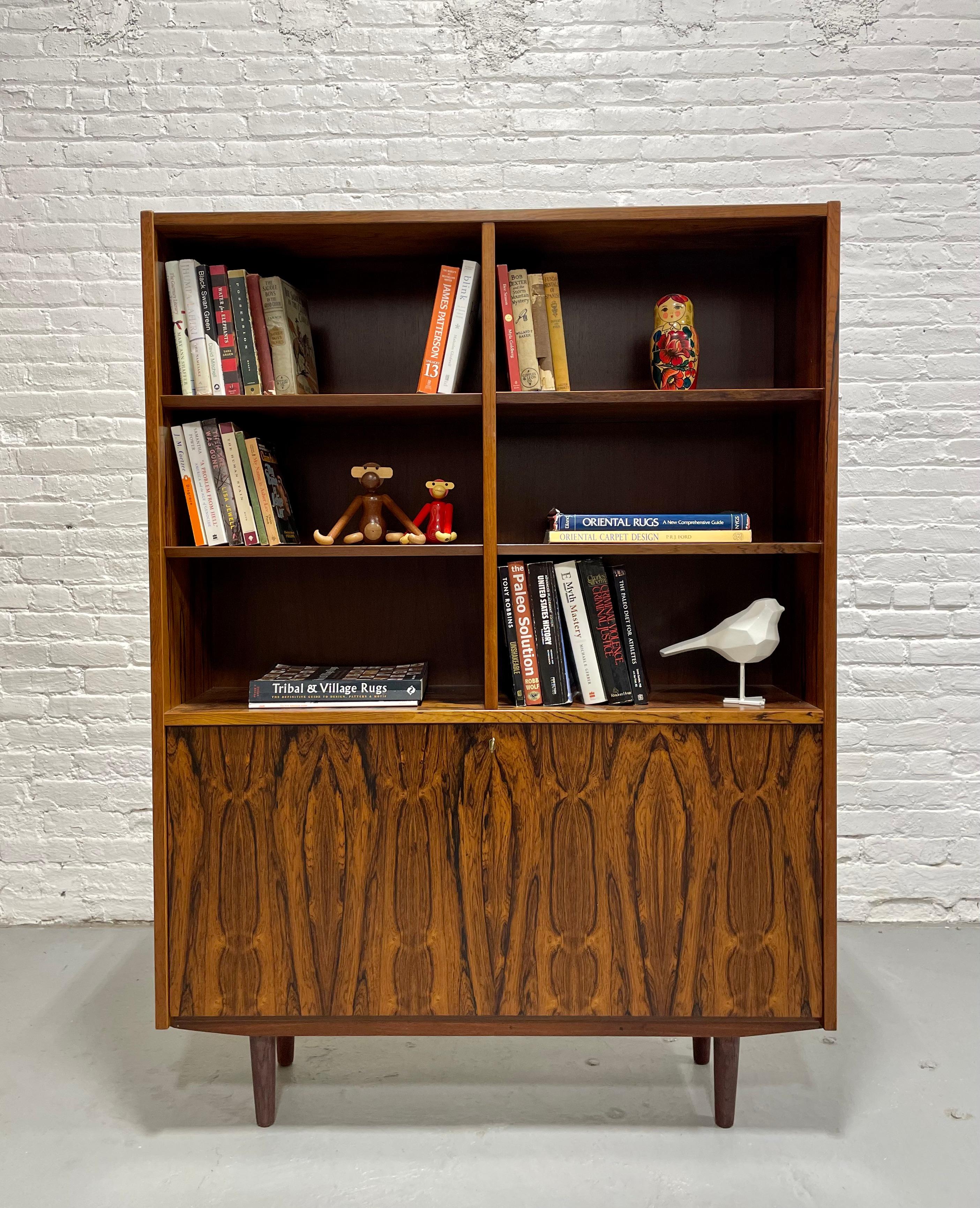 Mid Century Modern ROSEWOOD bookcase / China Cabinet, c. 1960's with super stand out wood grains. This stunning piece features 6 shelving areas in the upper area and all shelves are removable and adjustable. The lower area unlocks (yes, we have the
