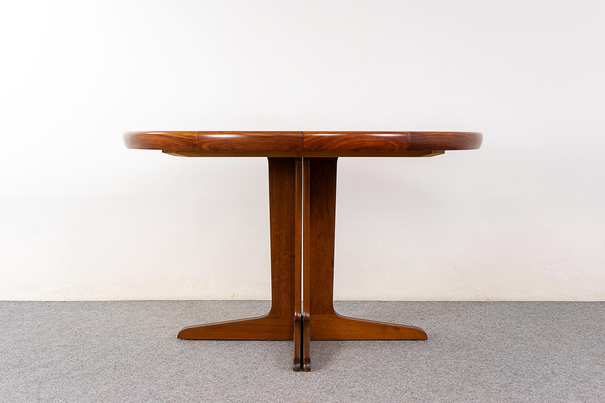 Rosewood mid-century dining table by V.V. Mobler, circa 1960's. Bookmatched veneer top with geometric solid wood scalloped trim. Sculpted pedestal base extends to support the leaves. Cozy, social circular shape to seat 4, add leaves to entertain 6