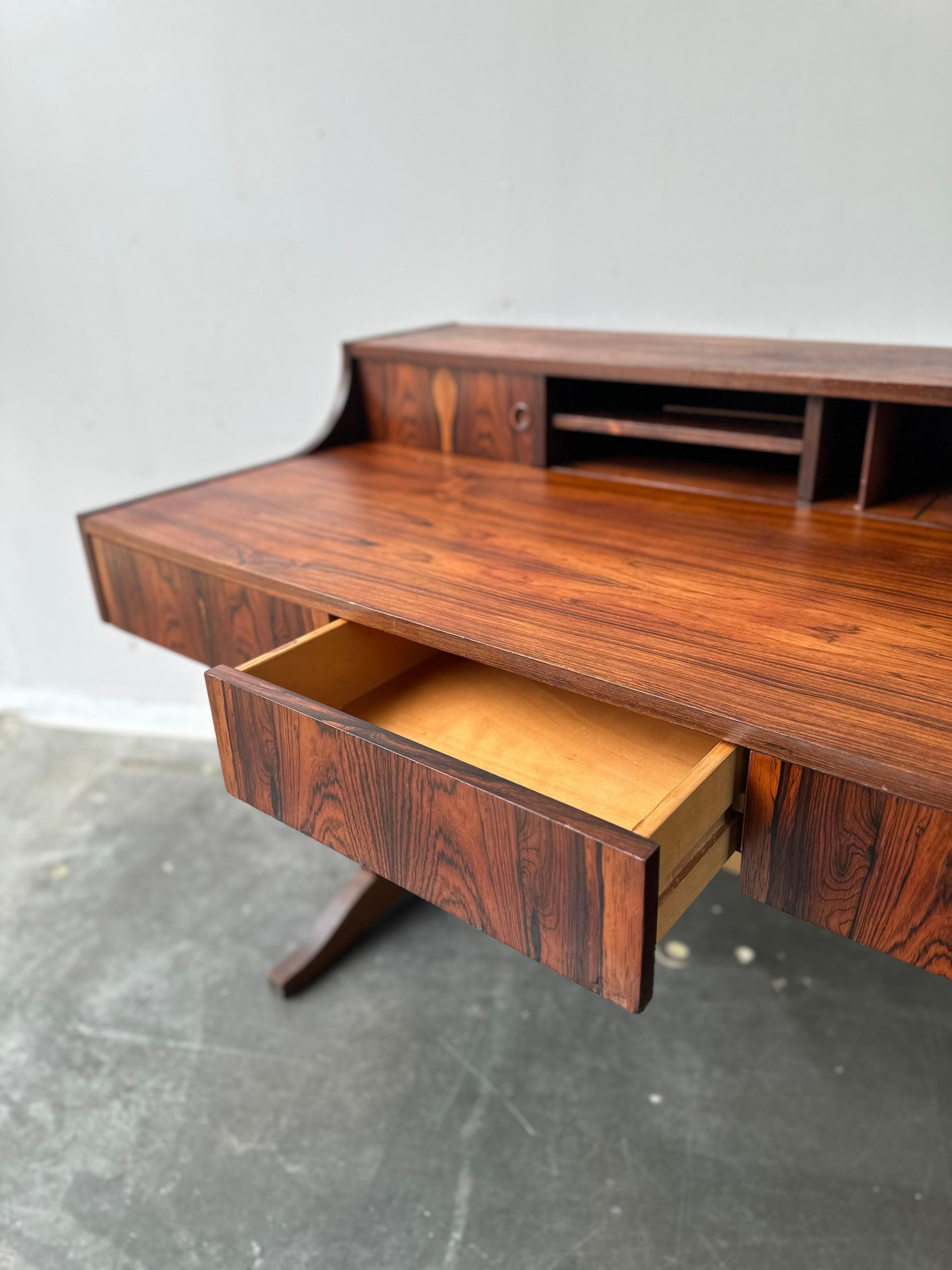 Stunning danish rosewood floating style desk with fantastic wood grain.

This piece is fabulous restored condition and is ready to be enjoyed.   Purchased from the original owners authentic mid century estate in NJ.

Dim: 34.5” D  x 50” L  x 28” H