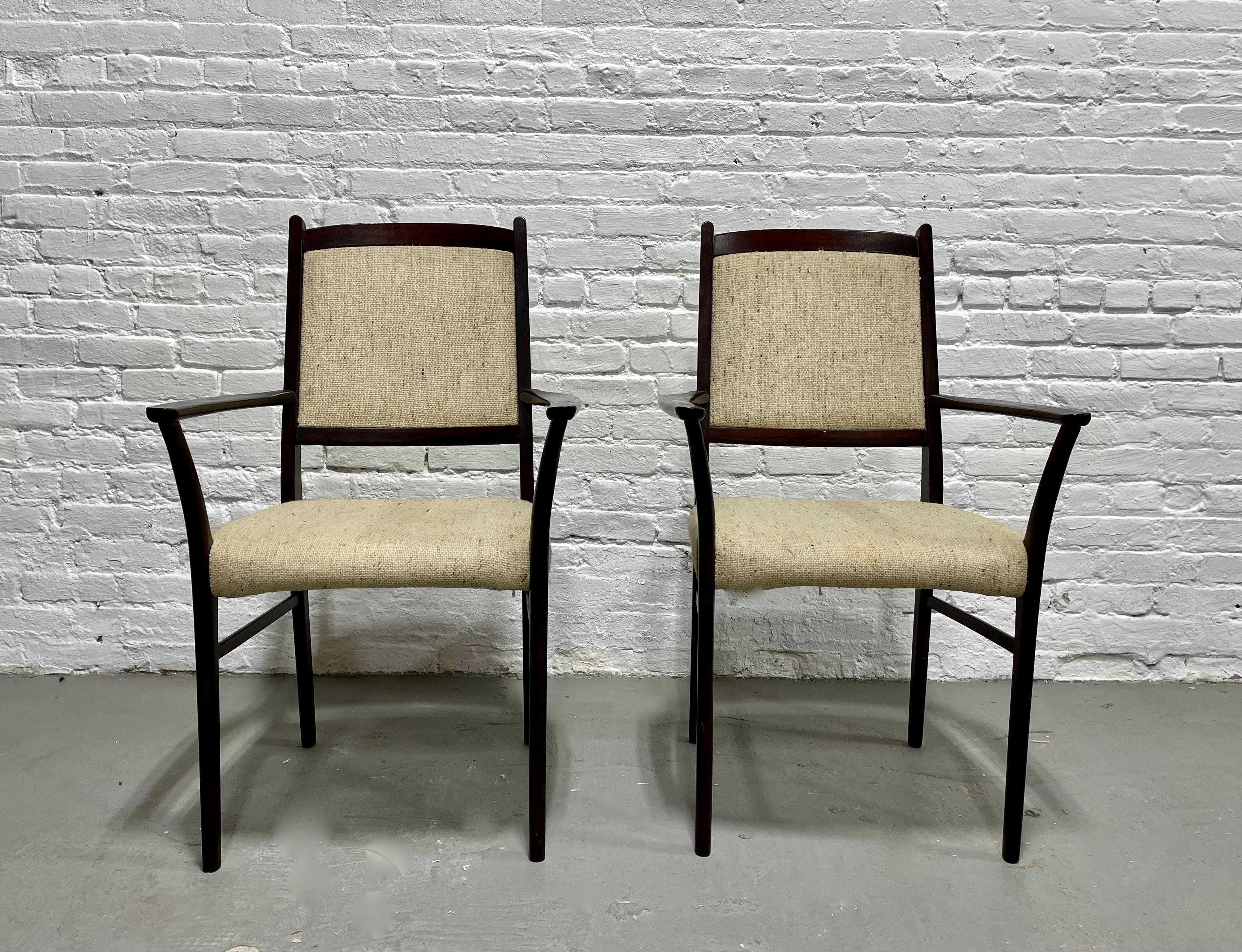 Pair of Danish Mid Century Modern Rosewood Dining Chairs, c. 1960's.  Simple, clean lines + perfect design featuring lovely oatmeal upholstery. Constructed in rosewood and its deep, rich color and stunning wood grains will add depth and design to