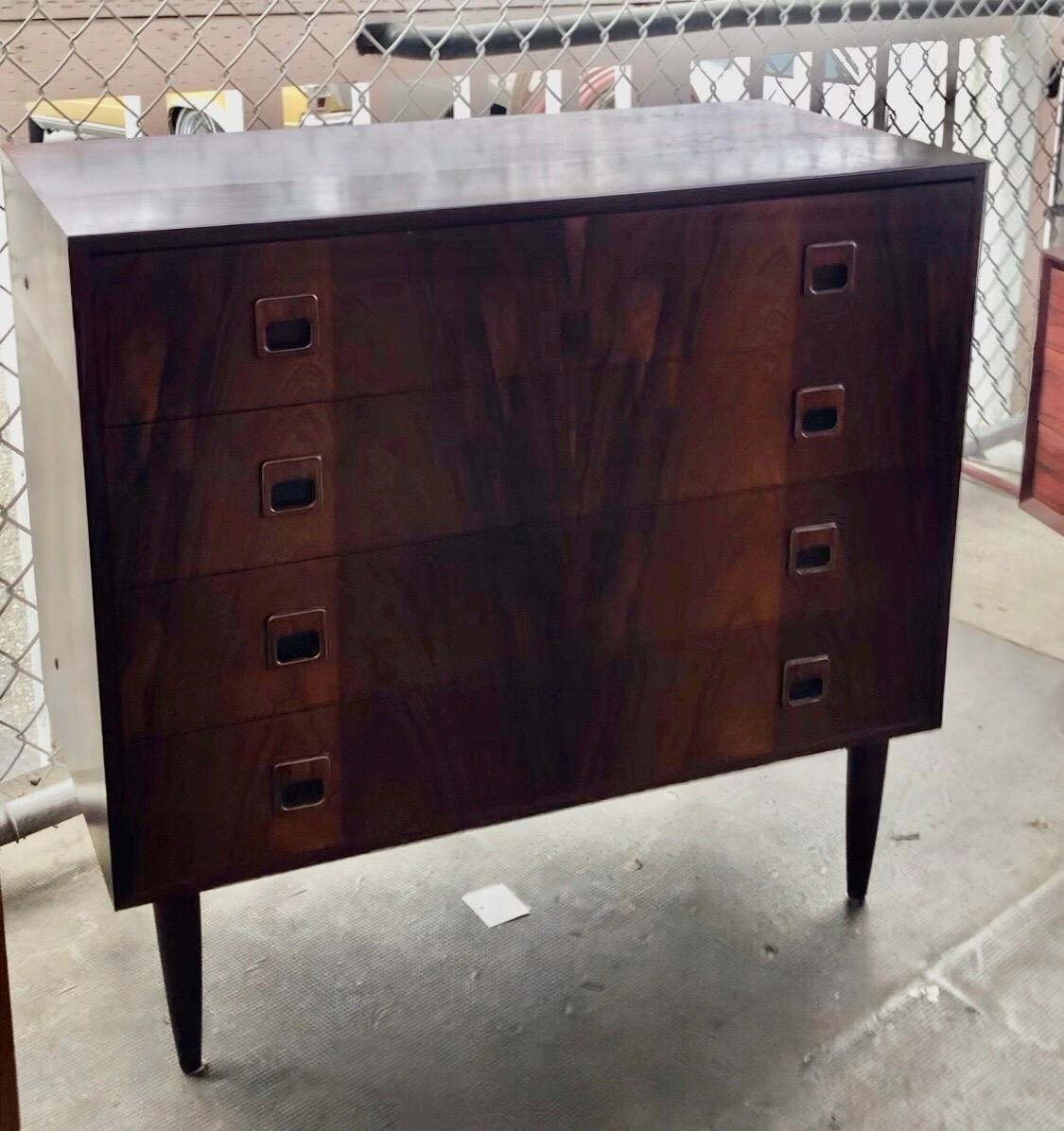 Gorgeous and highly sought after Danish rosewood dresser. Made in Denmark. Designer unknown.

Four drawers. Amazing grain pattern.