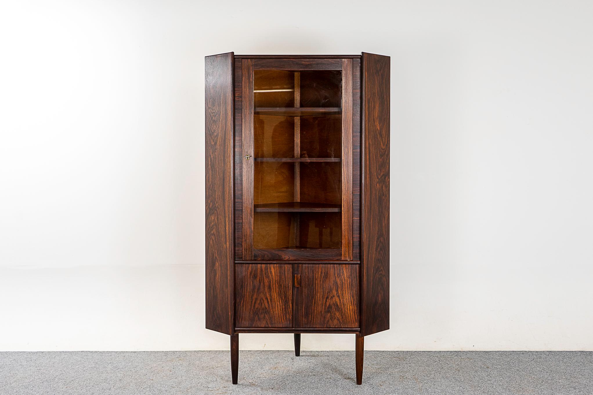 Rosewood & glass Danish corner cabinet, circa 1960s. Beautiful graining, new pristine glass and locking upper compartment. Make the most of that empty corner!

Please inquire for international shipping rates.