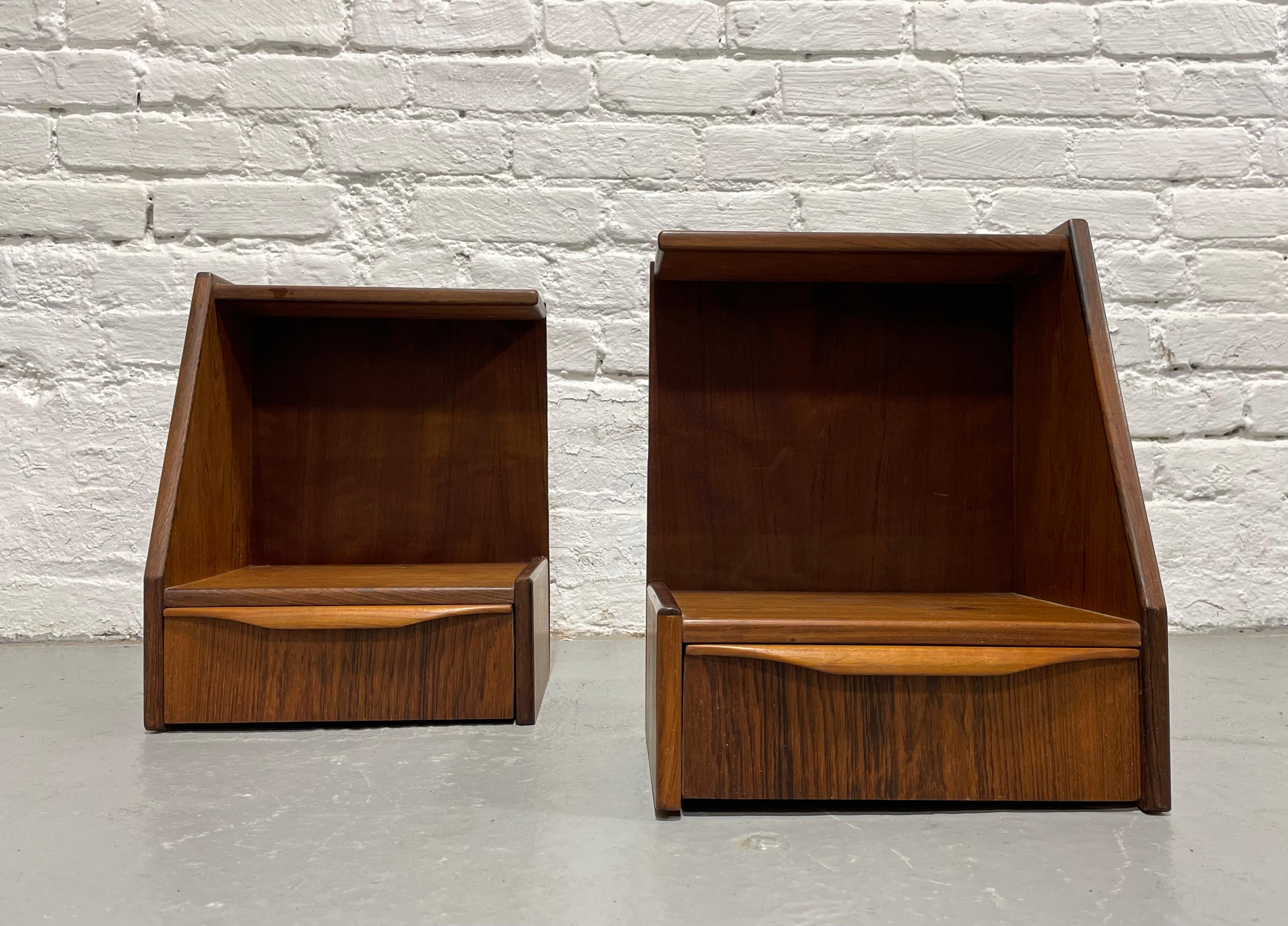 Petite pair of Danish Mid Century Modern Rosewood Hanging Nightstands / Bedside Tables, c. 1960's.  This set is perfect where space is limited as the nightstands will be affixed to your wall rather than taking up floor space.  This pair is a rare