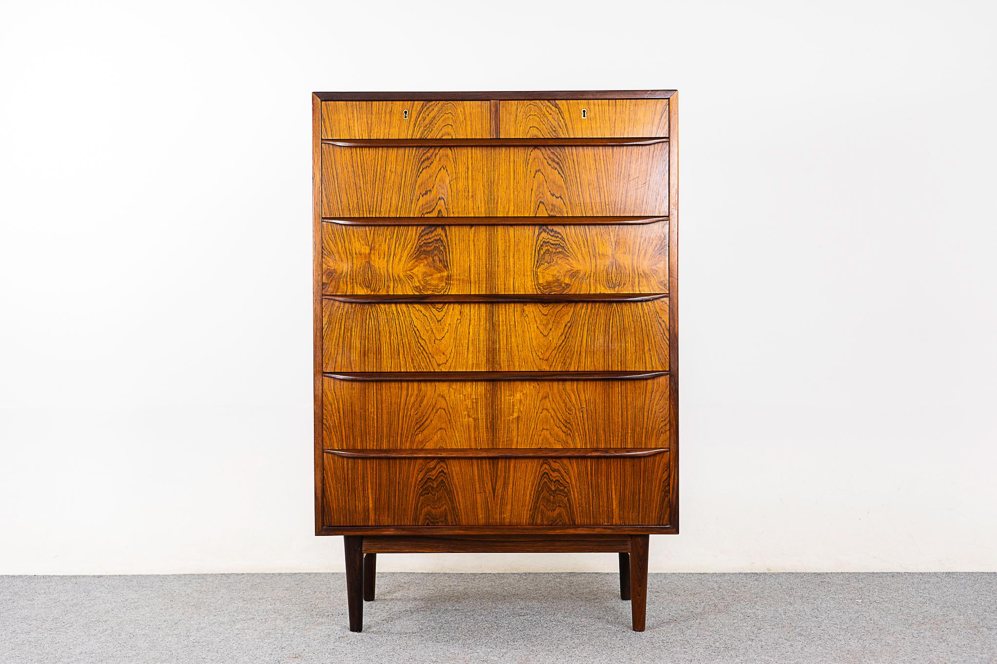 Rosewood mid-century dresser, circa 1960's. Stunning book-matched veneer on the drawer faces, simply beautiful. Integrated, horizontal drawer pulls and dovetail construction. Unique split top drawers!

Please inquire for remote and international