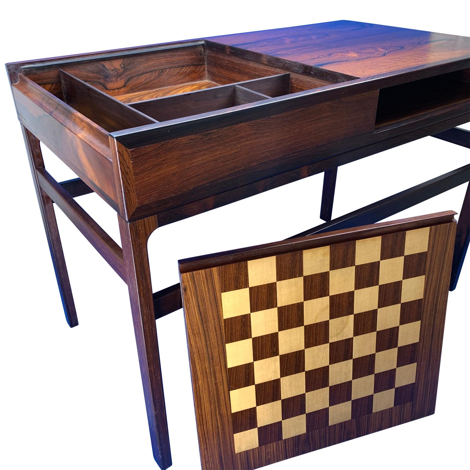 Amazing Danish Mid-Century Modern rosewood magazine and chess game table.
One half of the tabletop pulls out, flips to second as a chess board game. Compartments for chess pieces and deck of card under the flippable chess board.

Complimentary front