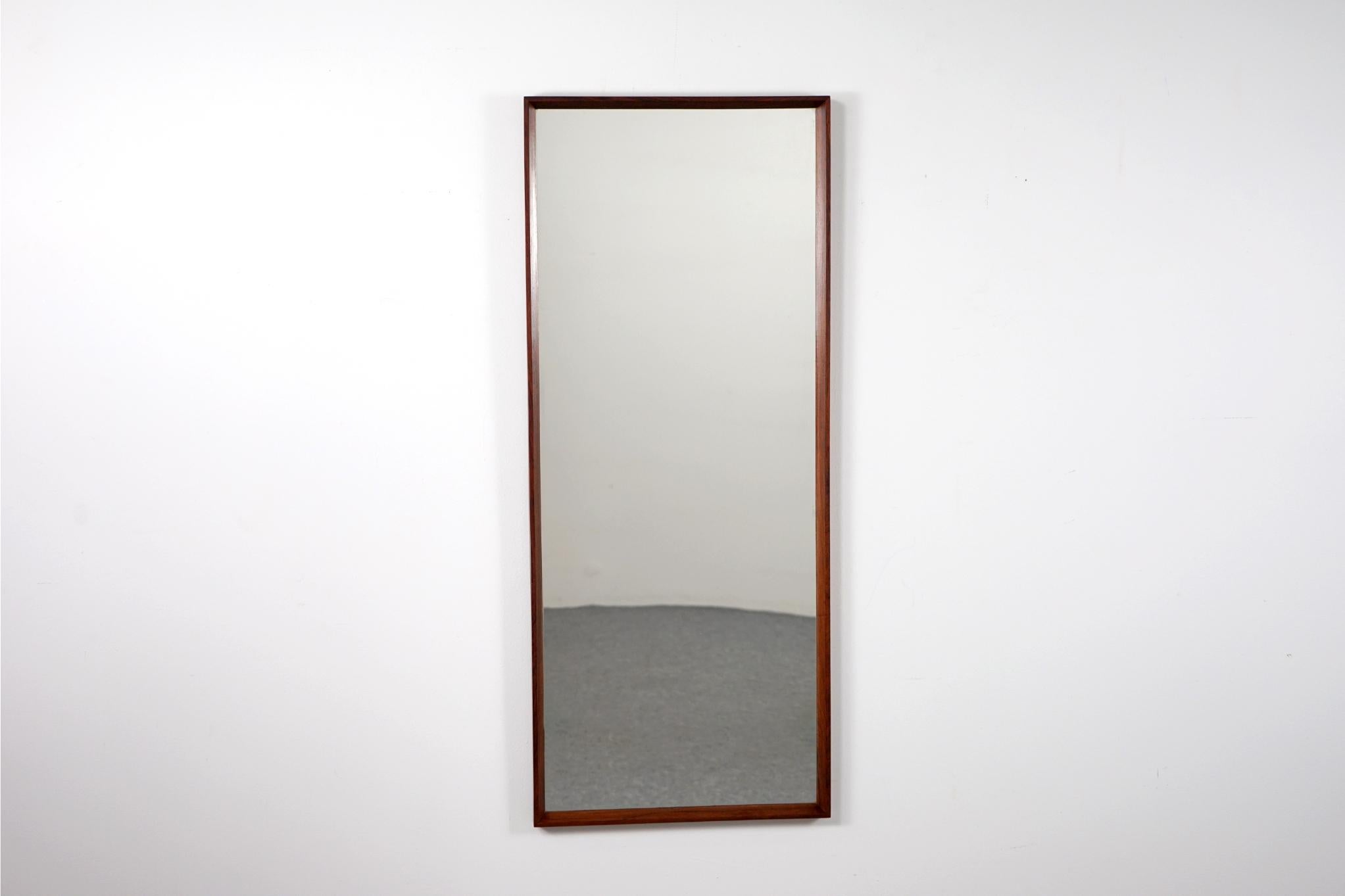 Rosewood mirror, circa 1960's. Solid wood frame shows stunning grain and mirror features its’ original glass. The perfect compliment to any interior especially in small apartments, condos and lofts where space can be tight. Check your look!

Please
