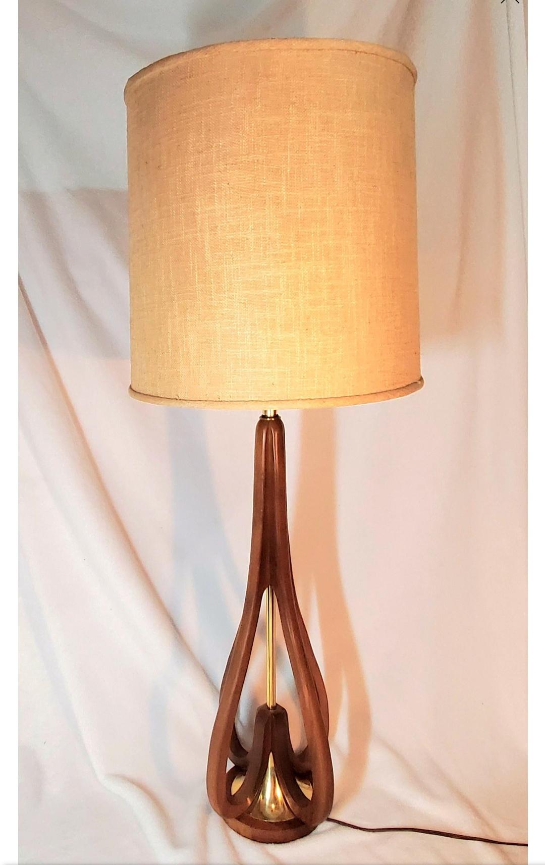 Could also be a floor lamp?

Stunning, sleek, modern...
Teak and brass sculptural floor/ table lamp.
Pre 1962.

Not the original shade, but age appropriate and can be included.
Shade is 14
