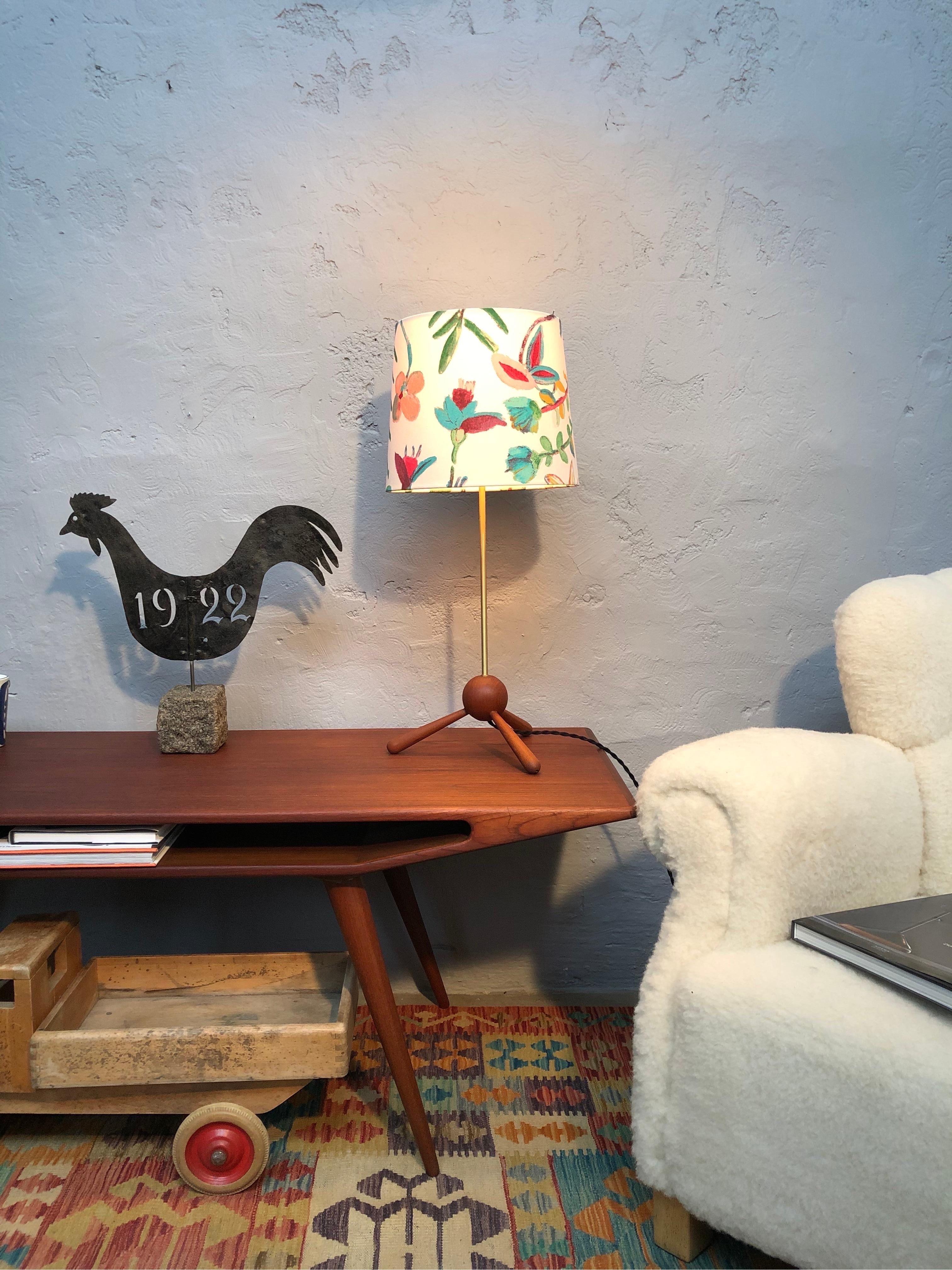 Vintage Danish Mid-Century Modern solid teak and brass table lamp with a very elegant period design. 
3 legged base in turned teak and with a brass upright. 
Rewired with a twisted cloth flex. 
Original E27 lamp holder. 
Can be fitted with an EU UK
