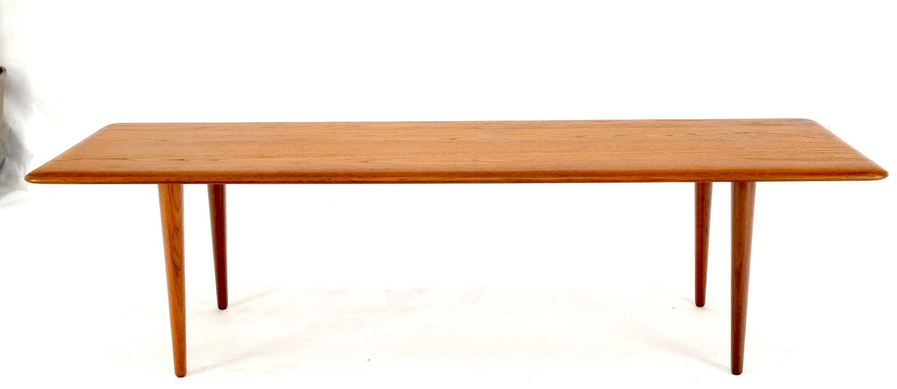 Danish Mid-Century Modern solid teak rectangle coffee table tapered dowel legs.
Hans Wegner, Peter Hvidt decor.