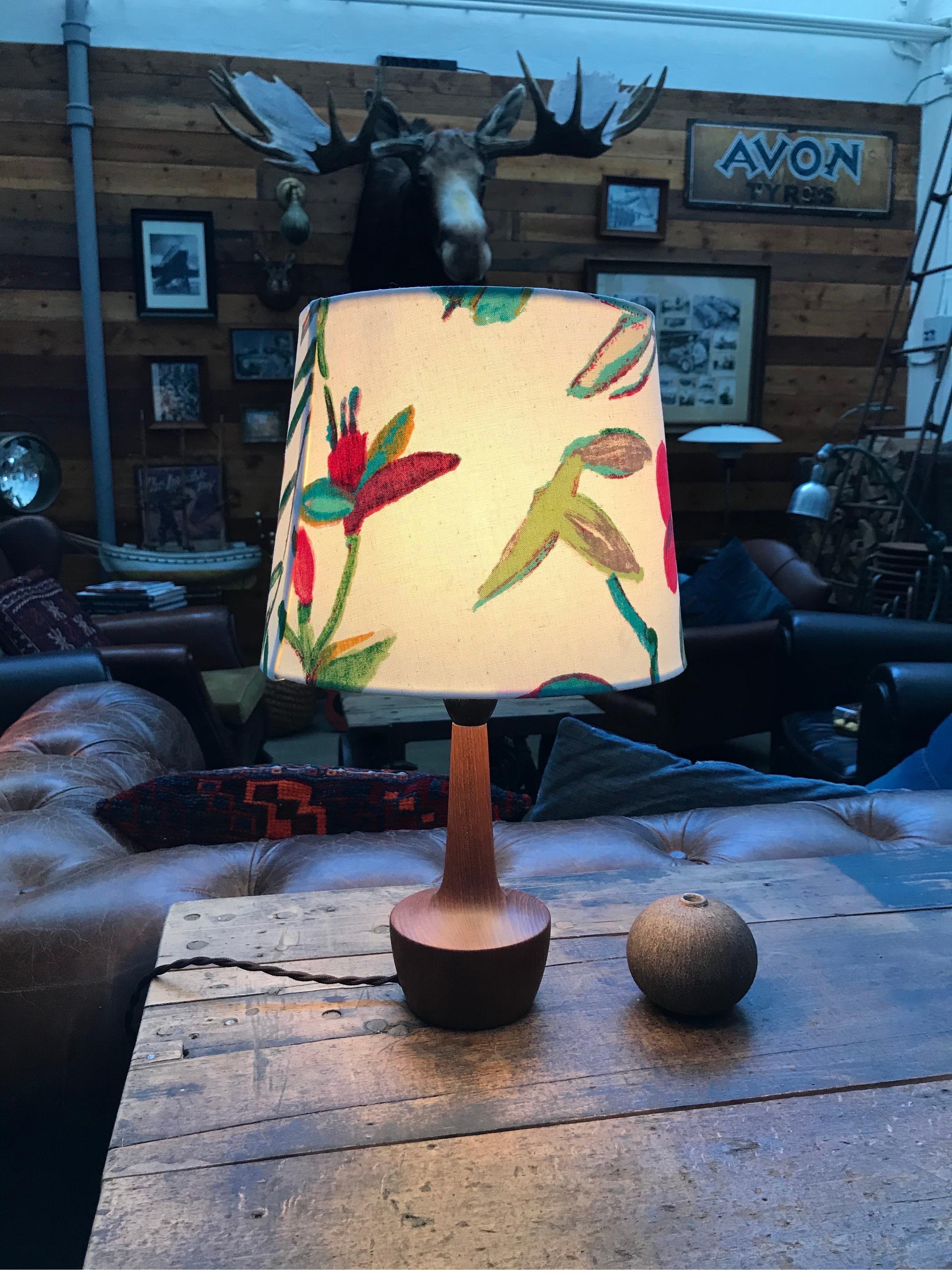 Danish Mid-Century Modern turned solid teak table lamp. 
Rewired with an in-line switch and topped with a limited edition lampshade from ArtbyMaj in the manner of Josef Frank.
This beautiful floral design on a white cotton background looks amazing